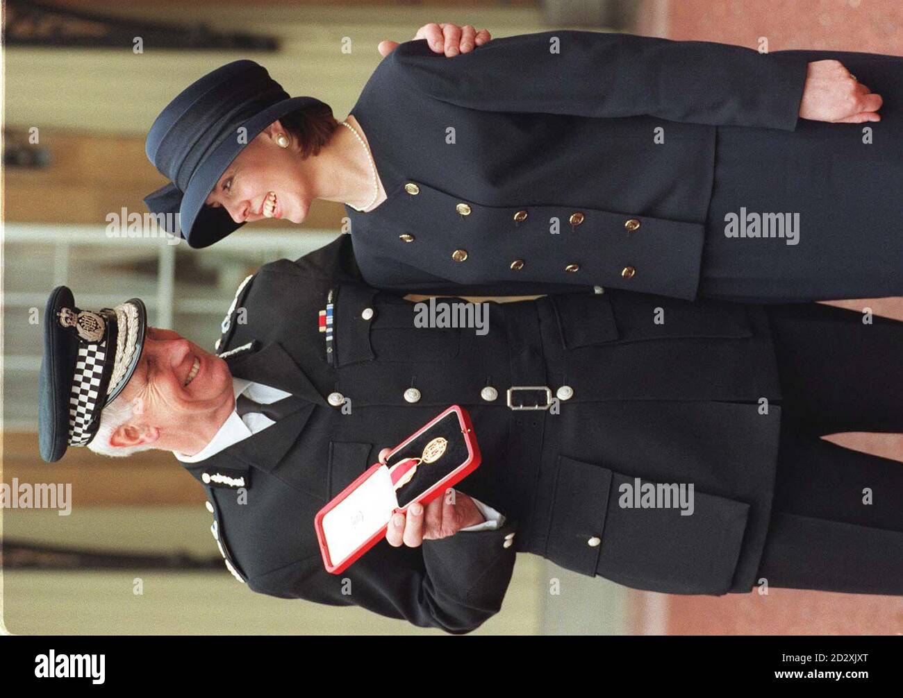 Sir Geoffrey Dear, HM Inspector of Constabulary, is accompanied by daughter Catherine Baldock at Buckingham Palace today (Tuesday), where he was presented with his knighthood by the Queen. See PA story ROYAL Forsyth. WPA Rota Photo by Fiona Hanson/PA Stock Photo