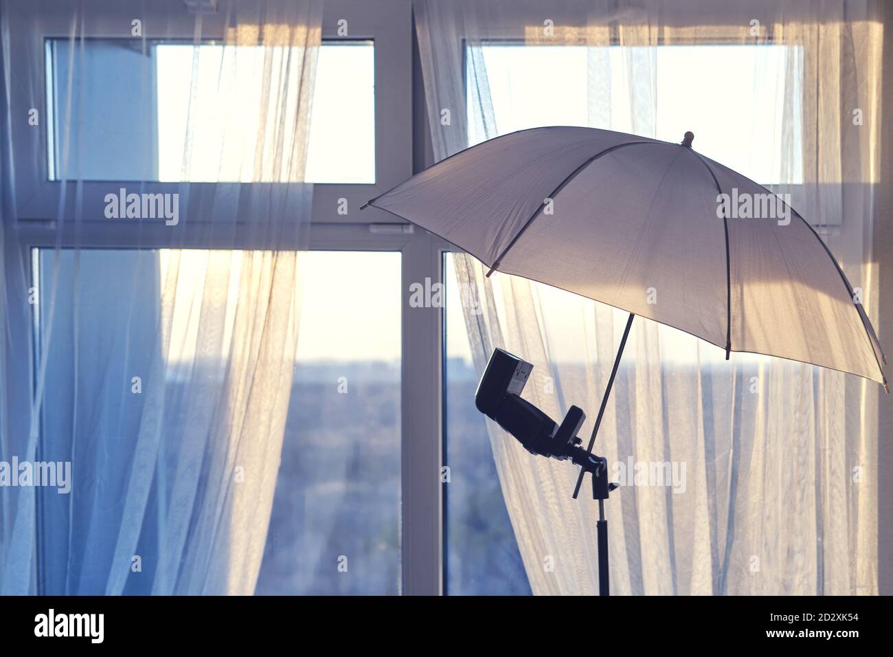 Umbrella and flash for the camera on the background of the home window