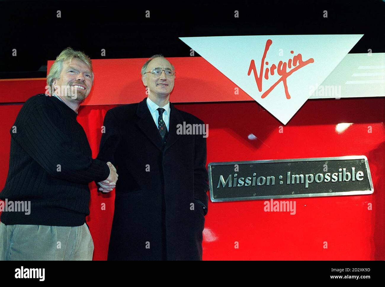 Richard Branson ( left)  and Transport Secretary Sir George Young at Euston today (Monday),  where  he launched  his new West Coast Main Line rail service with typical Virgin verve, as he waved away a gleaming Class 90 loco.  West Coast Main Line runs up the west side of England to Scotland and Virgin, together with Railtrack, which owns the lines and stations, plans to invest  2 billion in the route. Photo by David Cheskin. See PA Story RAIL Branson. Stock Photo