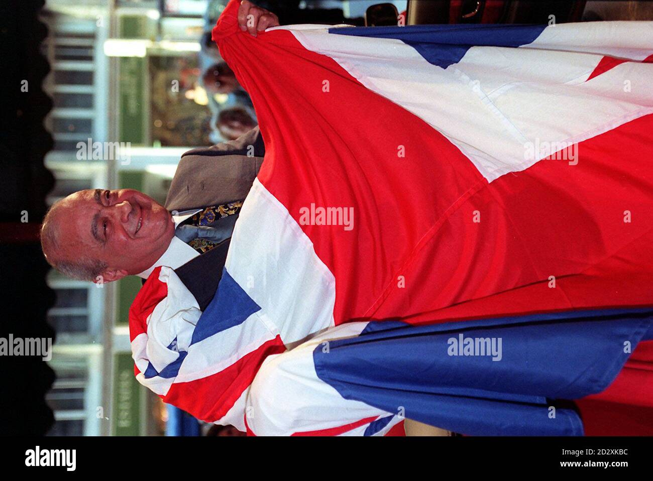 Harrods owner Mohamed Al Fayed wraps himself in a Union Jack flag at the London store. The Al Fayed brothers' battle for citizenship now looks set to be decided by the House of Lords. * after Home Secretary Michael Howard said he would appeal against the court ruling in their favour. Mohamed Al Fayed and his brother Ali, who were born in Egypt but have lived in the UK for 30 years, originally had their application for naturalisation turned down by the High Court. But the Court of Appeal overturned the ruling, deciding by a 2-1 majority that the brothers had not been treated fairly because the Stock Photo