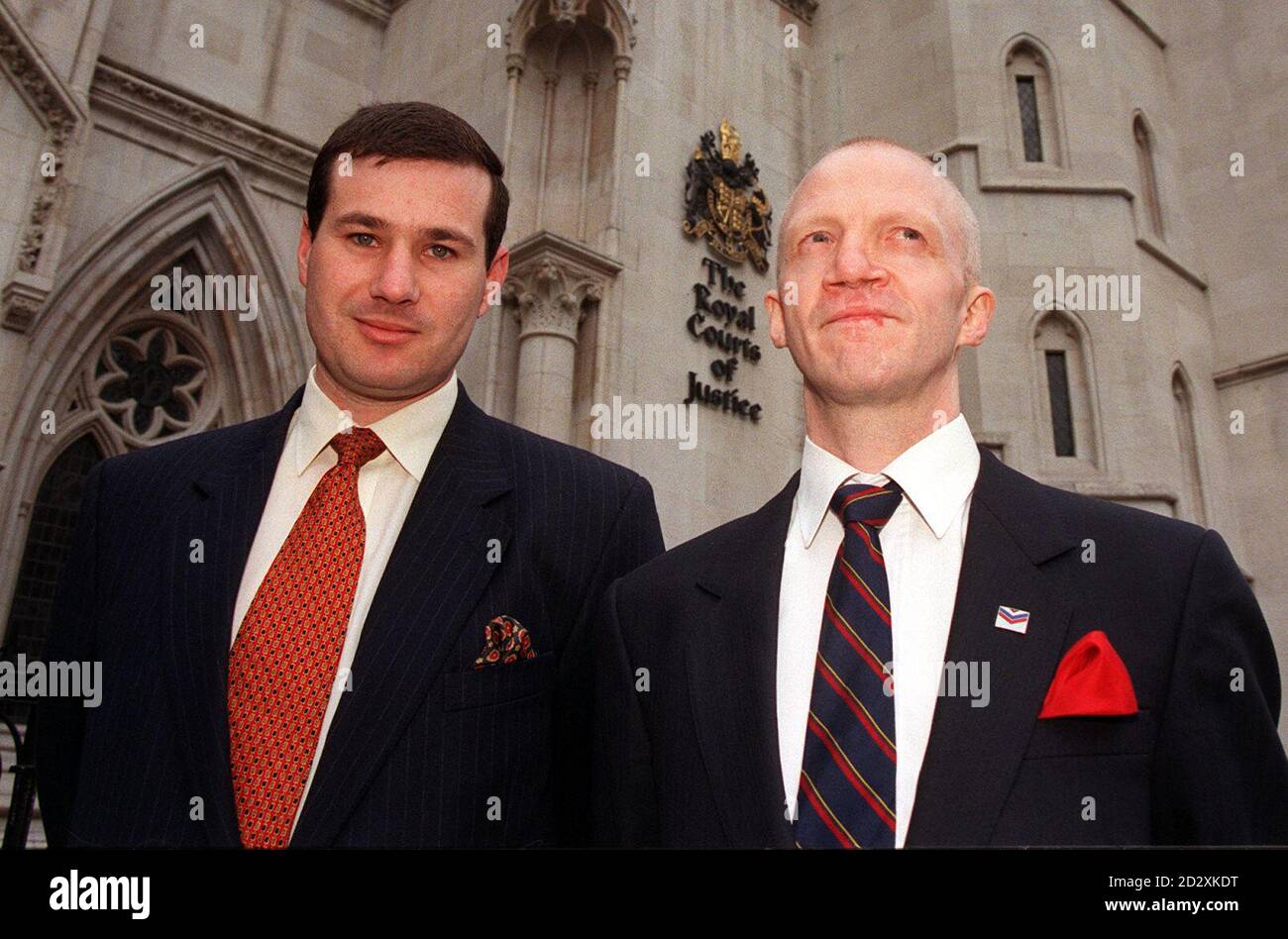 Duncan Lustig-Prean (left), who chairs Rank Outsiders, the group which has campaigned on behalf of gay servicemen, with right-hand man Mr T Cornish, vice-chairman of Rank Outsiders, outside the High Courts in London today (Thurs) after  a  judge ruled that the latest challenge to the ban on homosexuals from serving in the armed forces, brought by sacked Royal Navy medical assistant Terry Perkins, should be referred to Luxembourg, in the European Court of Justice. See PA Story COURTS Gay. Photo by David Giles. Stock Photo