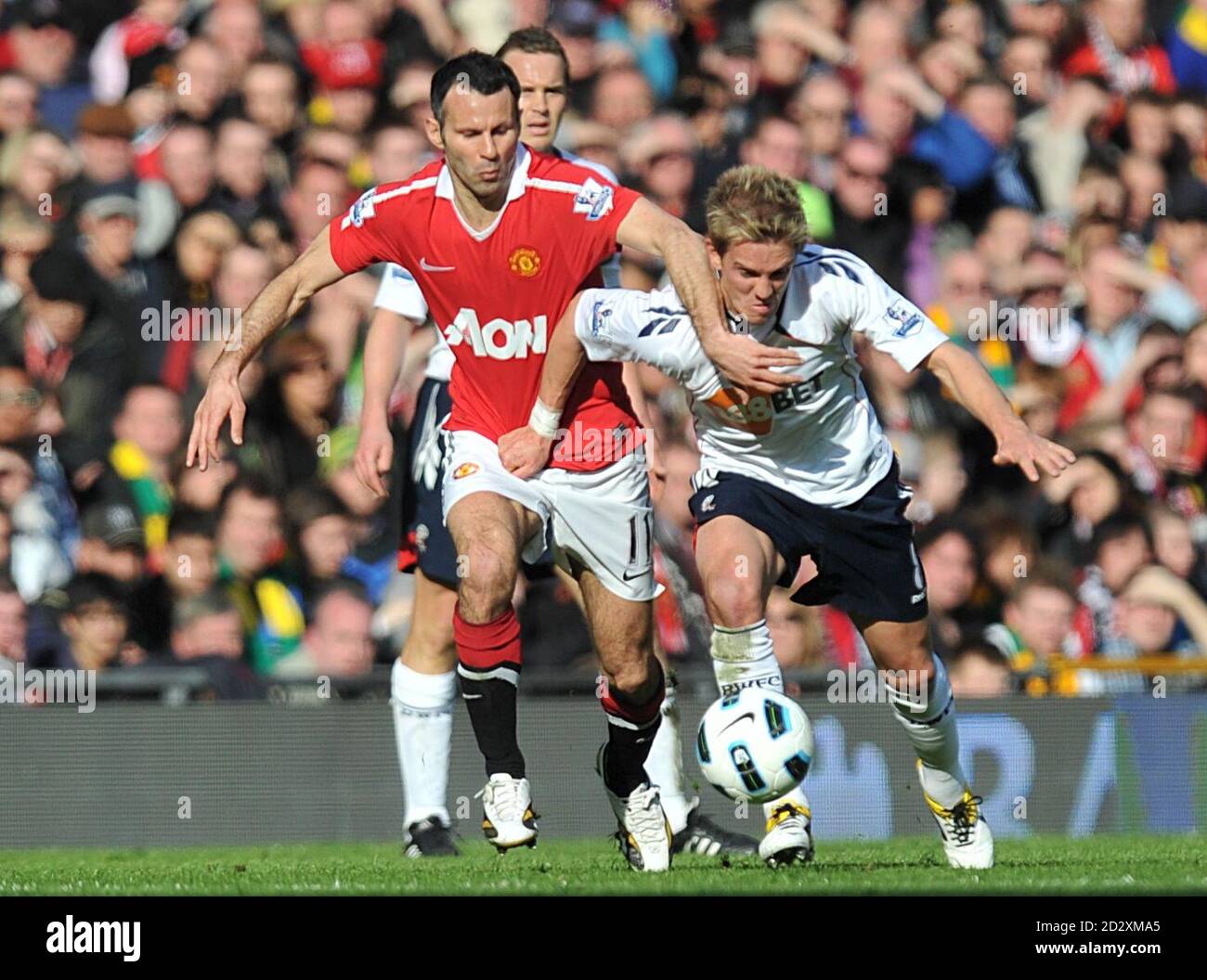 Manchester United's Ryan Giggs (left) and Bolton Wanderers' Stuart Holden (right) battle for the ball Stock Photo