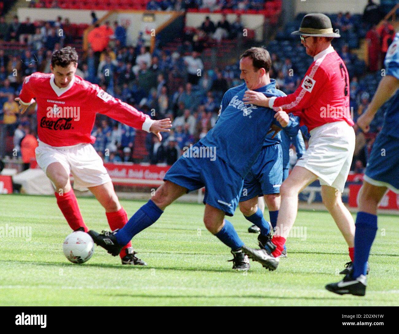 TV celeb Angus Deayton (centre) is tackled by presenter Chris Evans (right) during a charity football match before, this afternoon's Coca Cola Cup final between Middlesbrough and Leicester at Wembley. Picture by Martyn Hayhow Stock Photo