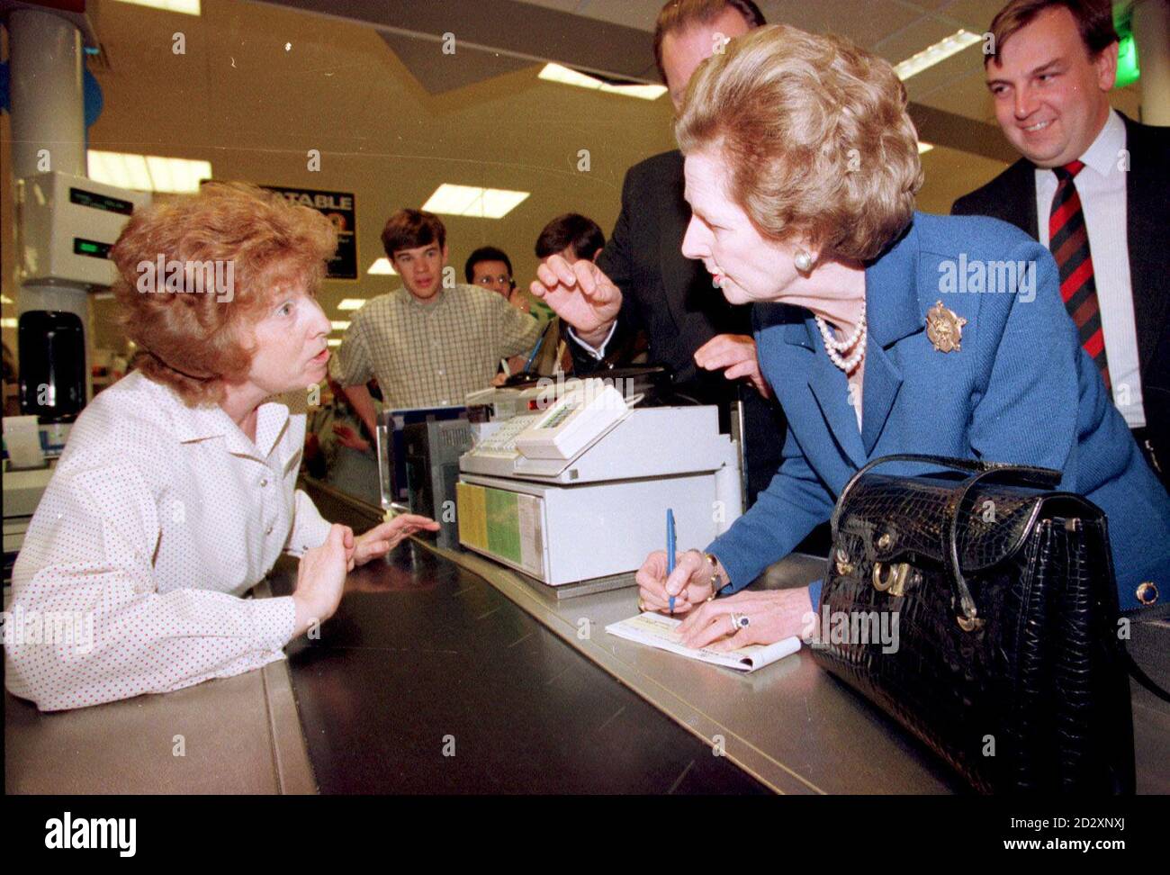 Baroness Thatcher on the Conservative campaign trail in Tesco's supermarket at Maldon, Essex today (Friday), where she had trouble buying her shopping, as check-out girl Shirley Taylor (Left) refuses her cheque because she has no cheque guarantee card. Photograph by Fiona Hanson/PA News. See PA Story ELECTION Thatcher. Stock Photo