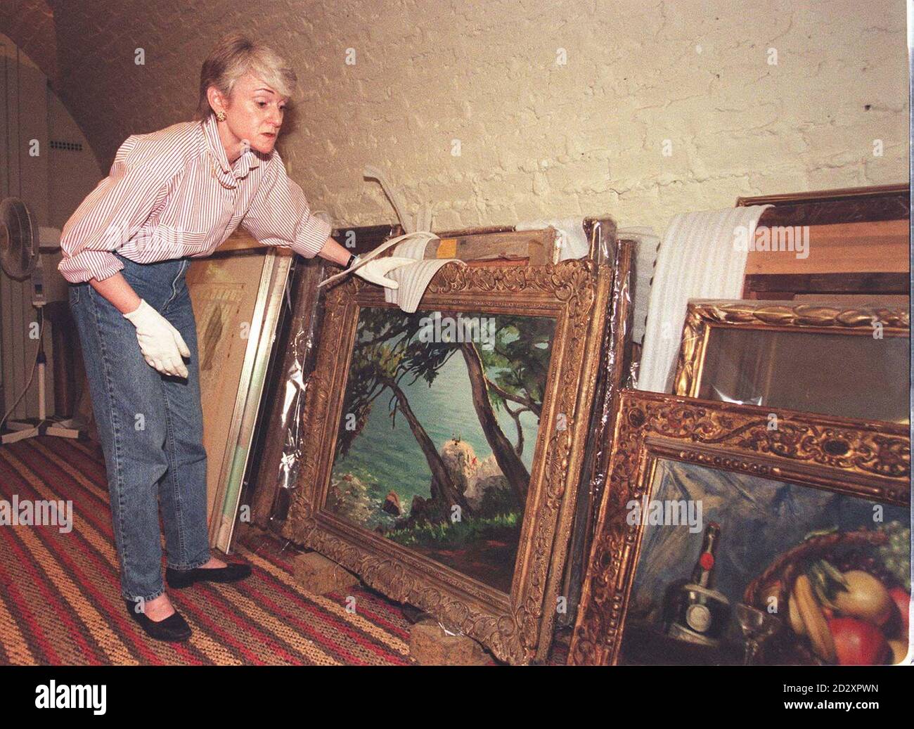 MaryAnne Stevens, Head of Education and Chief Curator at the Royal Academy, moves paintings from the picture store to the vault, to prevent water damage following a serious fire at the building last night. See PA story FIRE Academy. Pool Photo by Tony Harris/PA Stock Photo