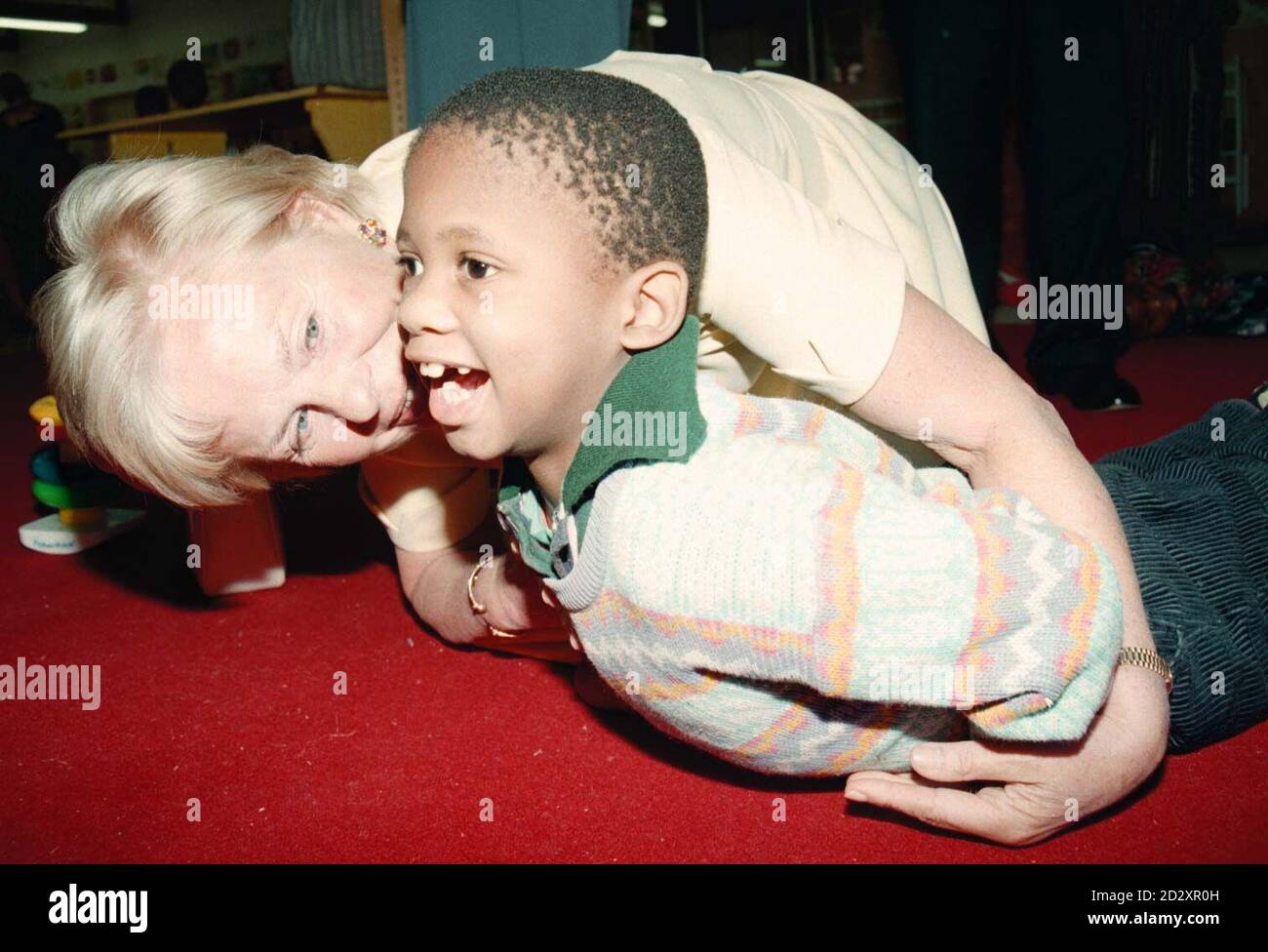 HRH The Duchess of Kent cradles a child with Cerebral Palsey at The Philani Nutrition and Rehabilitation Centre in Cape Town South Africa during her six day visit in her role as Patron of the UK Committee for UNICEF. Picture by Stefan Rousseau Stock Photo