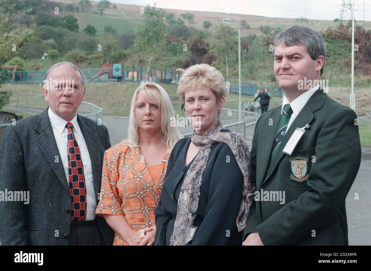(L to R) Mr Howell Jones, a former teacher at the village school in Aberfan, with ex-pupils Gaynor Madgwick, Janett Smart and Gareth Jones, who all survived the disaster on October 21, 1966, when an avalanche of coal waste engulfed the school. Survivors of the tragedy joined bereaved parents  today (Friday) as the Queen visited the site, now a tranquil memorial garden, where she planted a tree in remembrance of those who died. See PA story ROYAL Aberfan. Photo by John Stillwell/PA Stock Photo