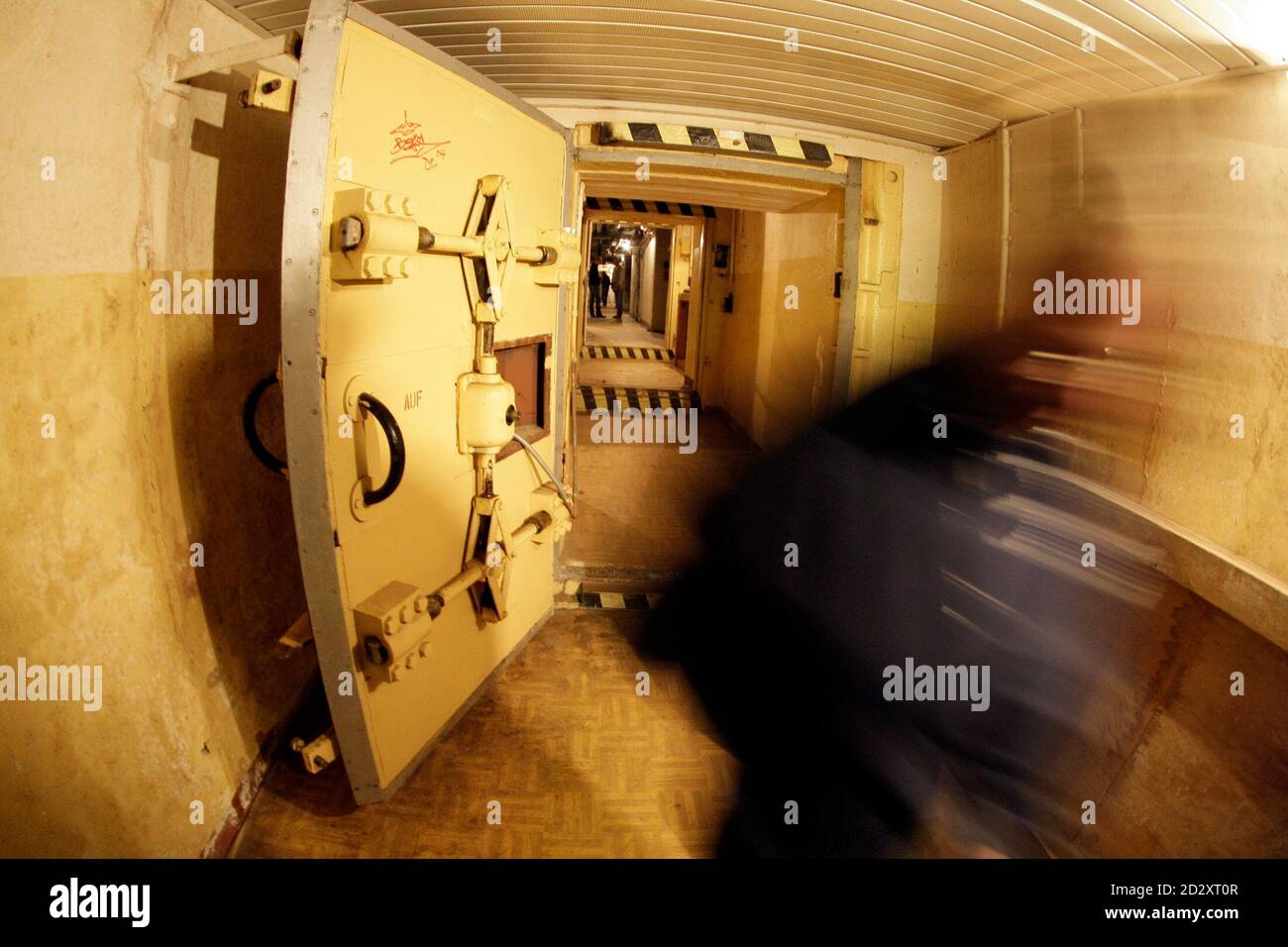 Journalists walk through a door of the so-called 'Honecker Bunker' in Prenden some 50 kilometres north of the German capital Berlin, August 1, 2008. The bunker officially called 'Objekt 17/5001', finished in the year 1983, has around 400 rooms at 6500 square metres on three floors and is opened to the public for the next three months.     REUTERS/Tobias Schwarz     (GERMANY) Stock Photo