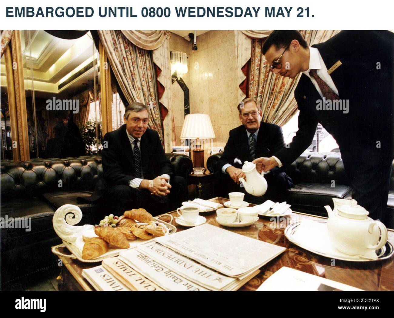 ** EMBARGOED UNTIL 0800 MAY 21** From left to right:  Richard North, Finance Director of Bass PLC, Sir Ian Prosser, Chairman of Bass PLC and hotel waiter. The company announces their interim results on Wednesday 21 May 1997. PA Photo. Stock Photo