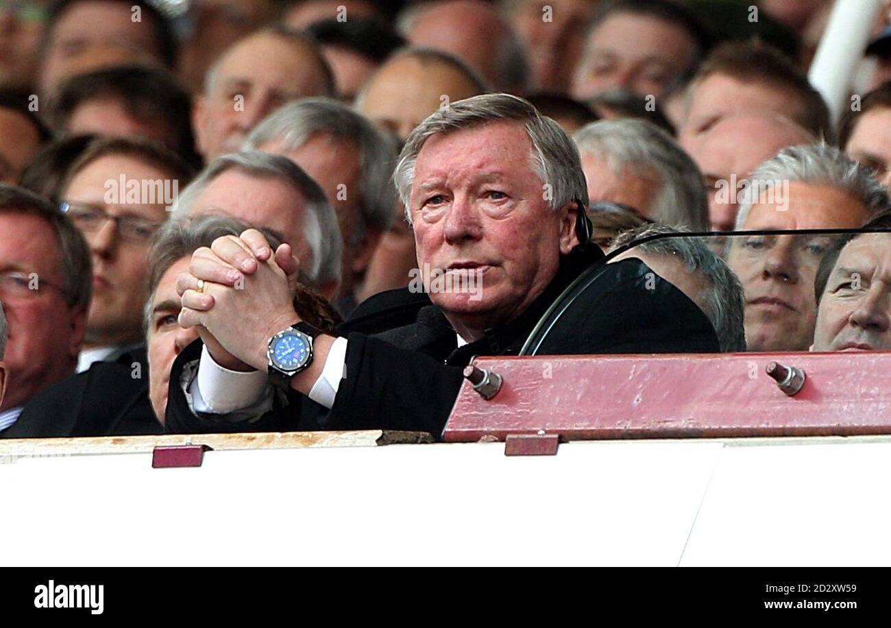 Manchester United manager Alex Ferguson (centre) sits dejected whilst watching the game from the stands Stock Photo