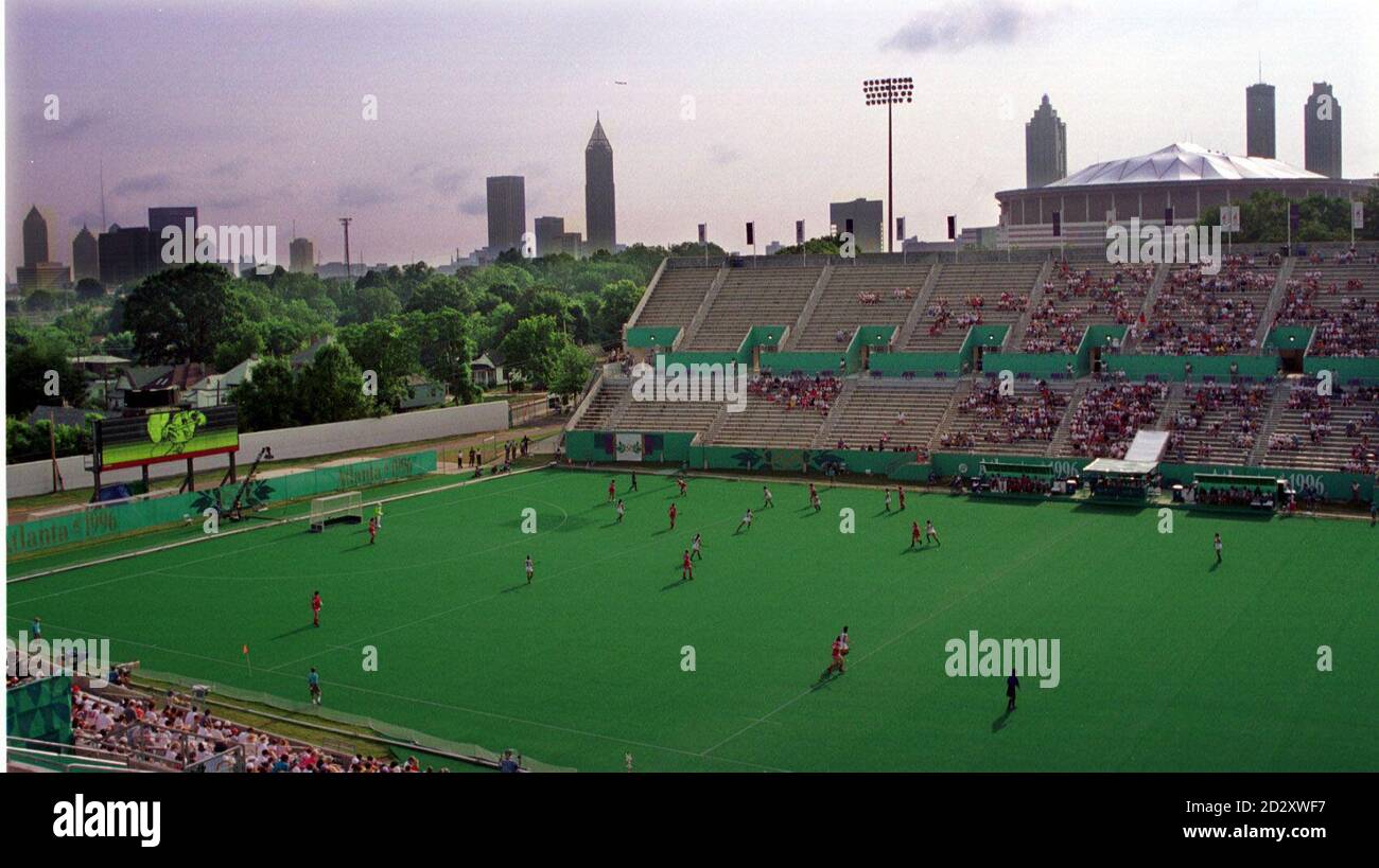With the Atlanta downtown skyline as a backdrop, the Great Britain women's field hockey team play Spain at Morris Brown College today. Photo By Rebecca Naden/PA Stock Photo