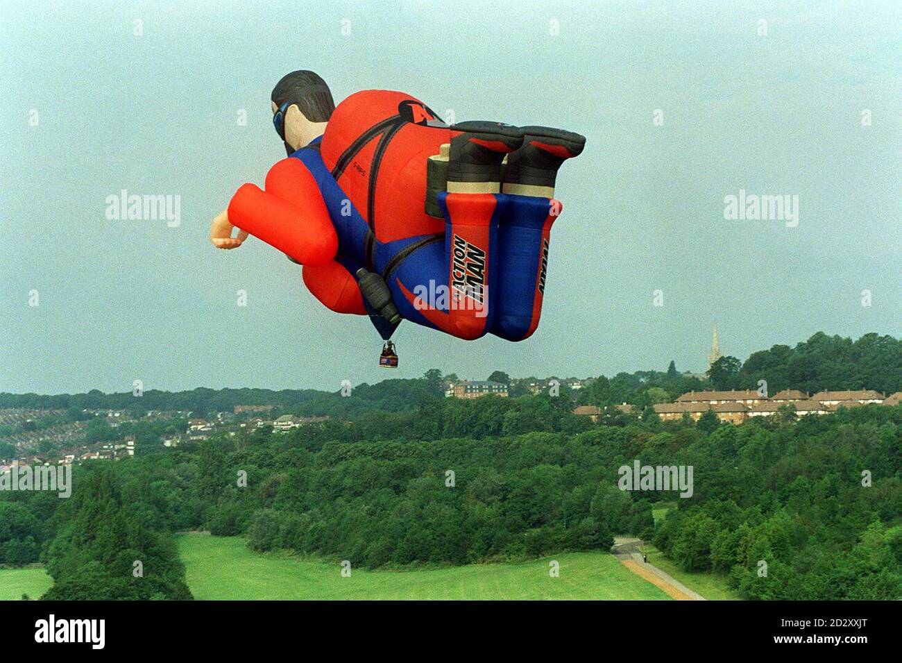 The world's biggest parachutist balloon, in the form of a 150 foot long,  rip-stop replica of the Sky Diver Action Man, "free-falling" over north  London in a trail of orange smoke today (