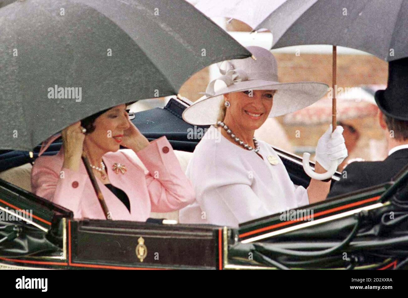 Princess Michael of Kent (right) and Lady Weinstock arrive under umbellas at a rain-drenched Royal Ascot today (Thursday) for Ladie's Day. Photo by Martyn Hayhow/PA Stock Photo