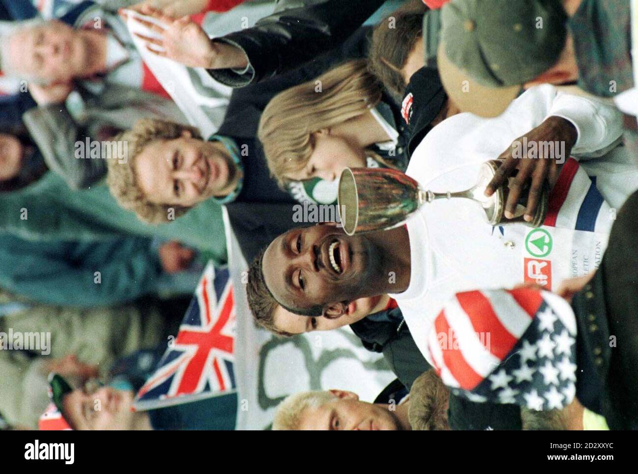 Linford Christie clutches the Men's European cup as he stands amongst the fans after the presentation ceremony at the Olympic Stadium in Munich today (Sunday). Christie retires from international competition after this meeting. Picture DAVID JONES/PA Stock Photo