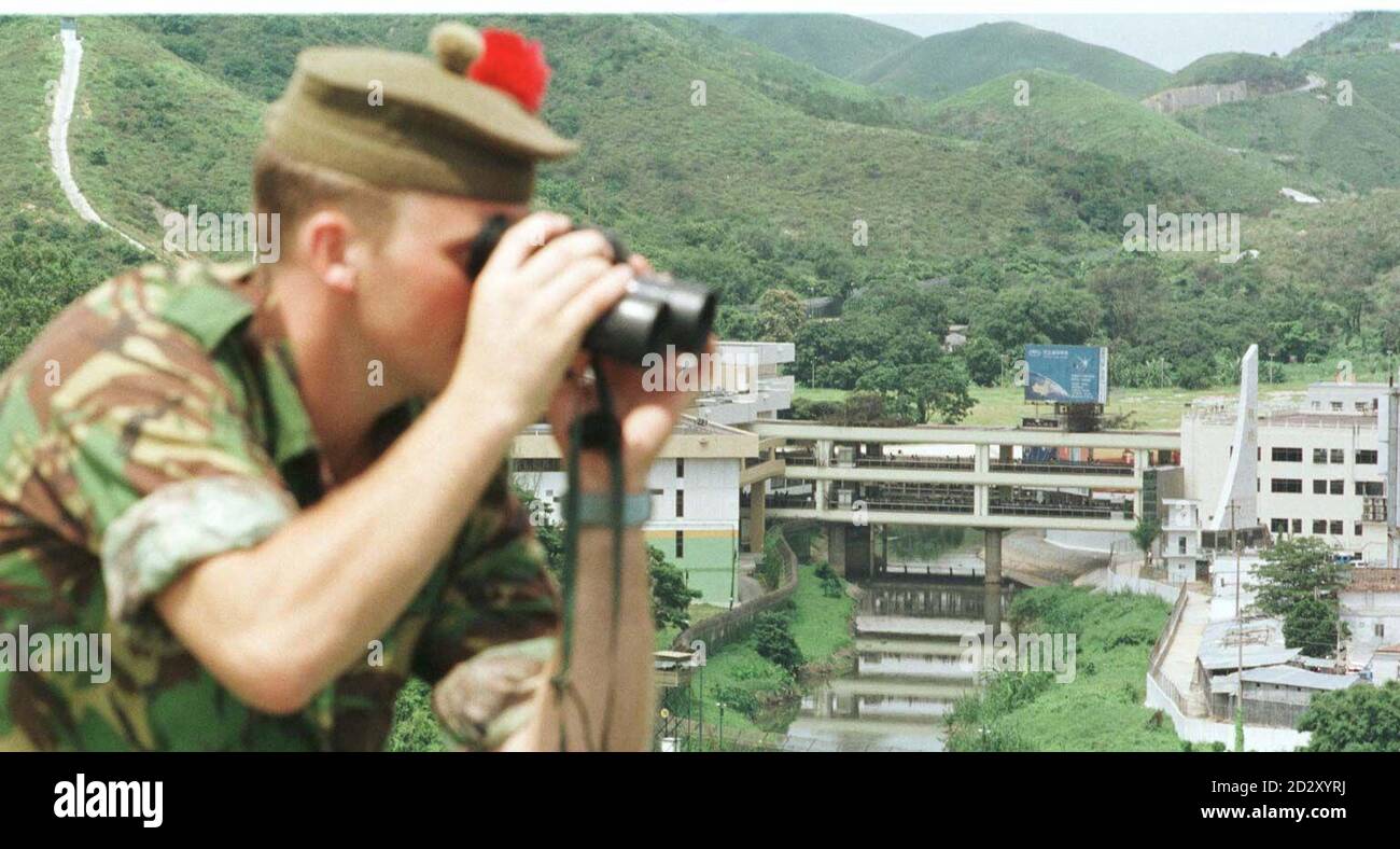Private Chris Richmond of the Black Watch, keeps a look out over the river border crossing between, the new territories of Hong Kong and China. The river border is near the Chinese city of Shenzhen, where the People's Liberation Army are expected to cross on Tuesday morning. PHOTOGRAPH BY JOHN STILLWELL/PA. Stock Photo