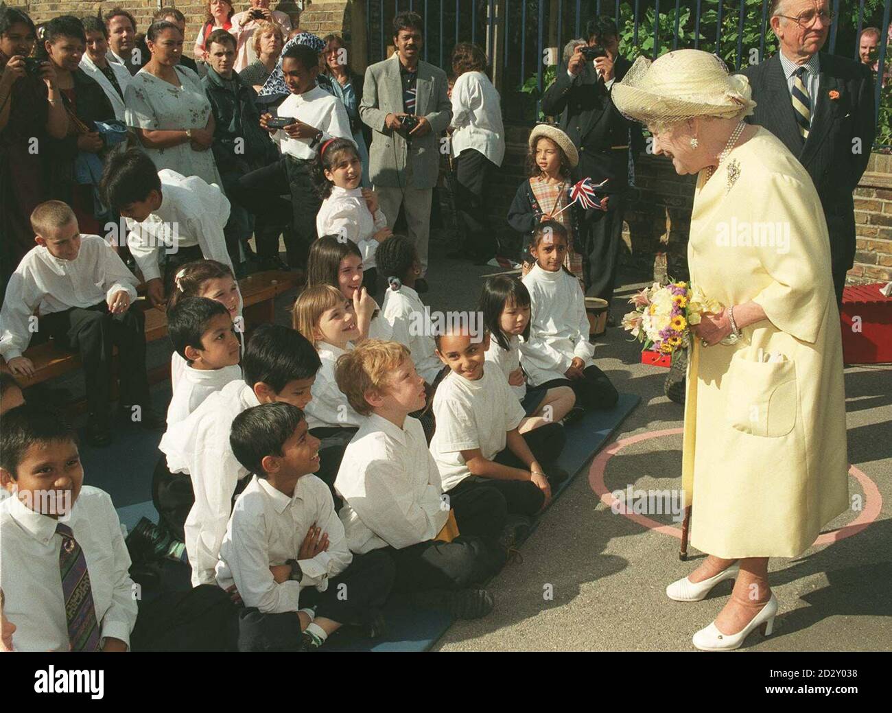 The Queen Mother meets pupils during a visit to Malmesbury Junior School, Bow, east London, for a garden party in her honour as patron of the London Children's Flower Society. Photo by Tony Harris/PA Stock Photo