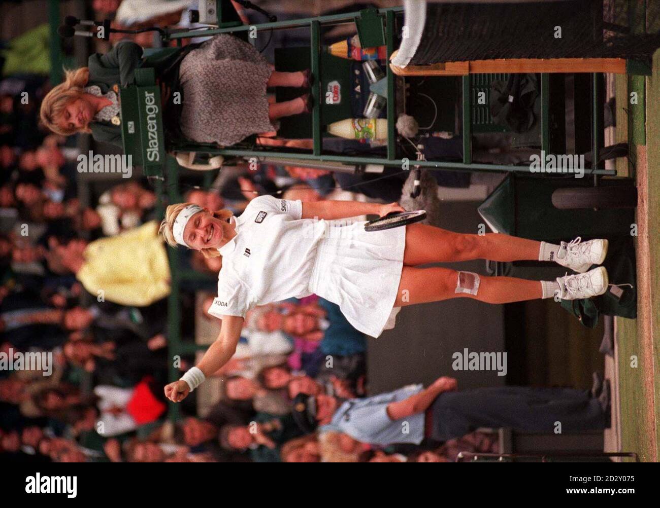 Jana Novotna smiles and leaps in the air as she walks back to her seat