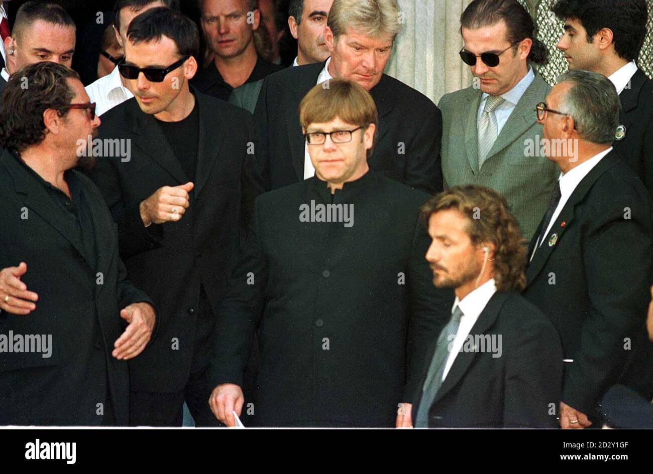 Singer Elton John (front centre) leaves the memorial service for murdered  fashion designer Gianni Versace with his partner David Furnish (2nd left)  in Milan, Italy Stock Photo - Alamy