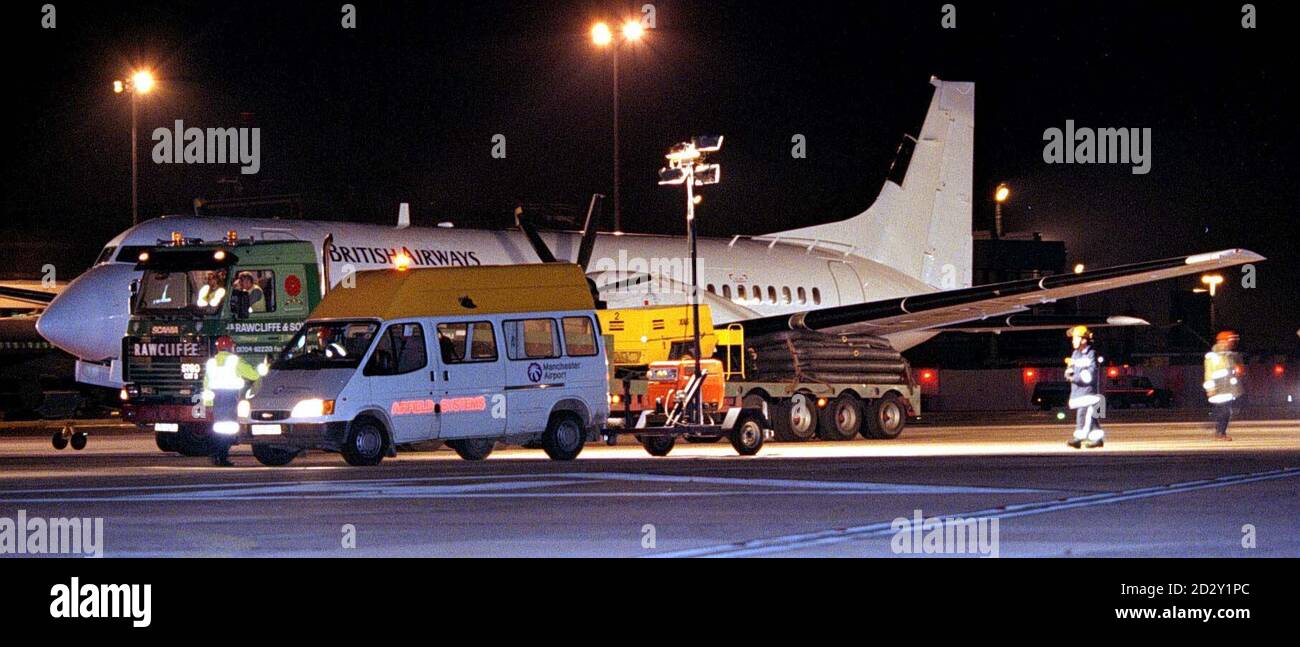 The British Aerospace ATP (Advanced Turbo-Prop) plane is towed from the runway at Manchester Airport tonight (Sunday) after it landed with a failed port side undercarriage. POOLPhoto by Dave Kendall/PA. See PA Story AIR Emergency Stock Photo