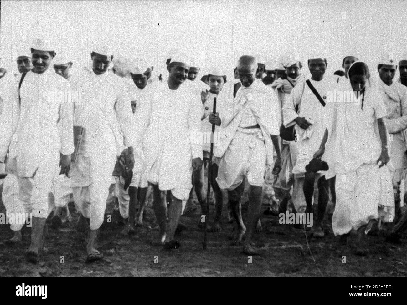 Library filer dated 06.04.30. Civil Disobedience in India. Mr. Gandhi (with staff in hand) and his volunteeers marching to the sea face at Dandi on the morning of April 6th, when they broke the Salt laws. 25.04.30. Mahatma Gandhi became widely known as the man credited with securing India's independence. He had led a campaign of non-violent resistance to British rule for decades. But, on the day the sun finally set on the British Raj in India at the stroke of midnight on August 14 1947, and Gandhi's goal was realised, he could not rejoicing for long. Jubilant scenes across the country qui Stock Photo