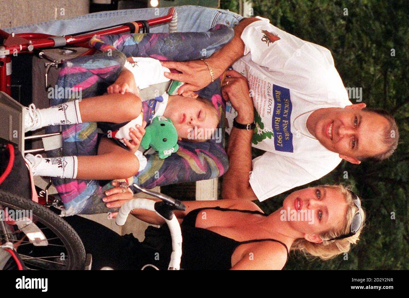Ex Page 3 model Suzanne Mizzi with Barry Daniels and his son Rhys who suffers from Batten's Disease outside Sticky Fingers Restaurant in London today (Monday) - the final destination for the 'Ride for Rhys' fundraising bike ride.  The Daniels Trust was first launched in 1994 at the London Sticky Fingers and raises money to support families with seriously ill children. Photo by Neil Munns/PA Stock Photo