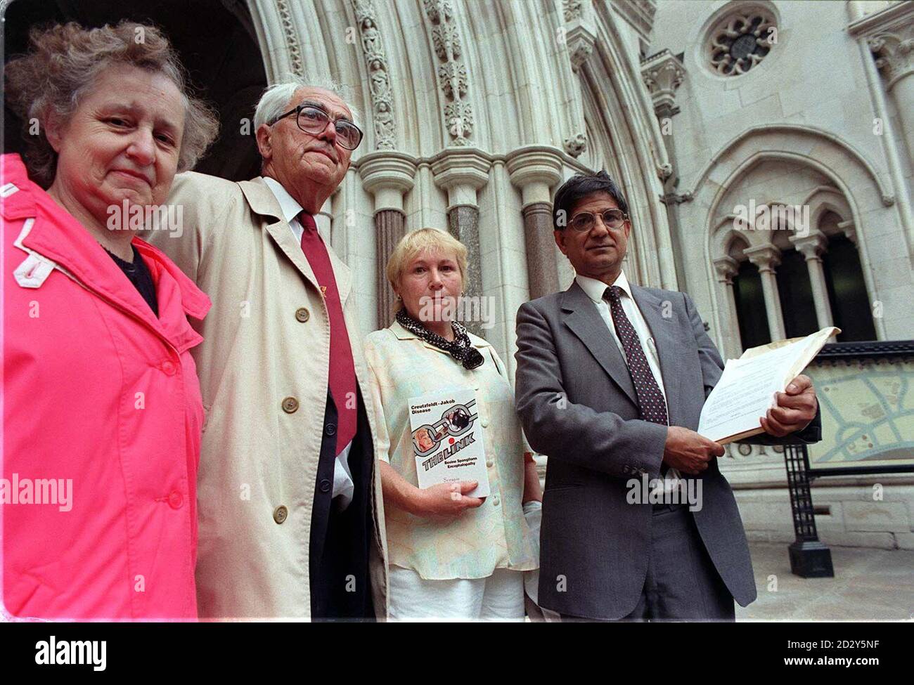 Scientist Dr Harash Narang (right), a specialist on Creutzfeldt-Jakob disease (CJD), outside the Royal Courts of Justice in London, today (Thursday) where he is launching an action alleging malicious falsehood against the Public Health Laboratory Service Board and two other named defendants. Pictured with Dr Narang are relatives of CJD victims (l/r) Margaret Ammon 63, from Surrey, John Williams, 68, from Carnavan and Wendy Bowden from Guildford. Photo by Ben Curtis. See PA Story COURTS Scientist. Stock Photo