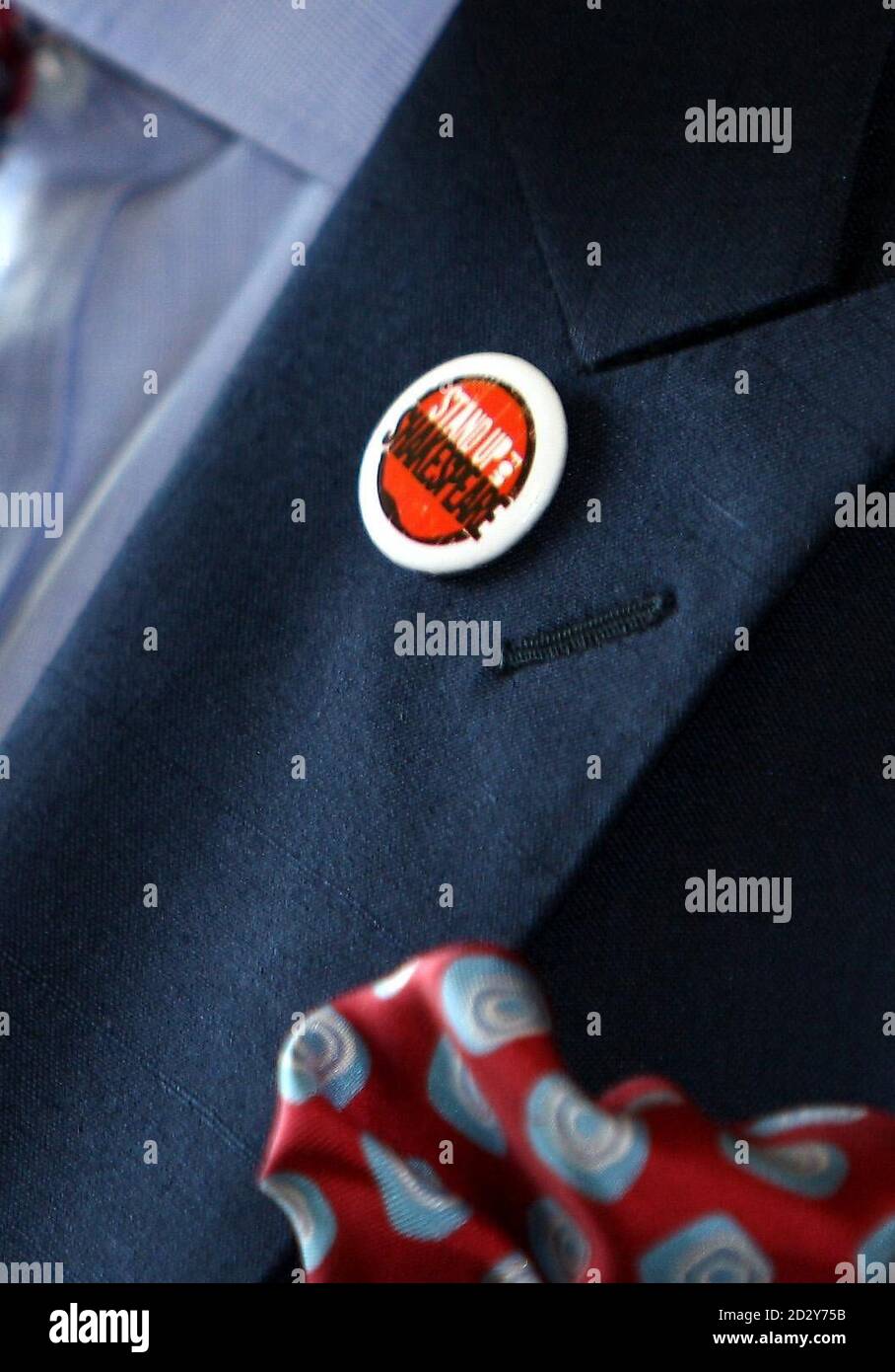 A badge is seen on the lapel of the Prince of Wales as he meets admirers on arrival at the newly rebuilt Royal Shakespeare Theatre at Stratford-upon-Avon, ahead of the RSC's 50th Birthday Gala Performance of Macbeth. Stock Photo