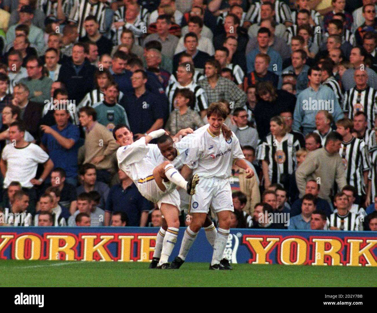 Leeds United celebrate while Newcastle fans stay silent as Harry Kewell