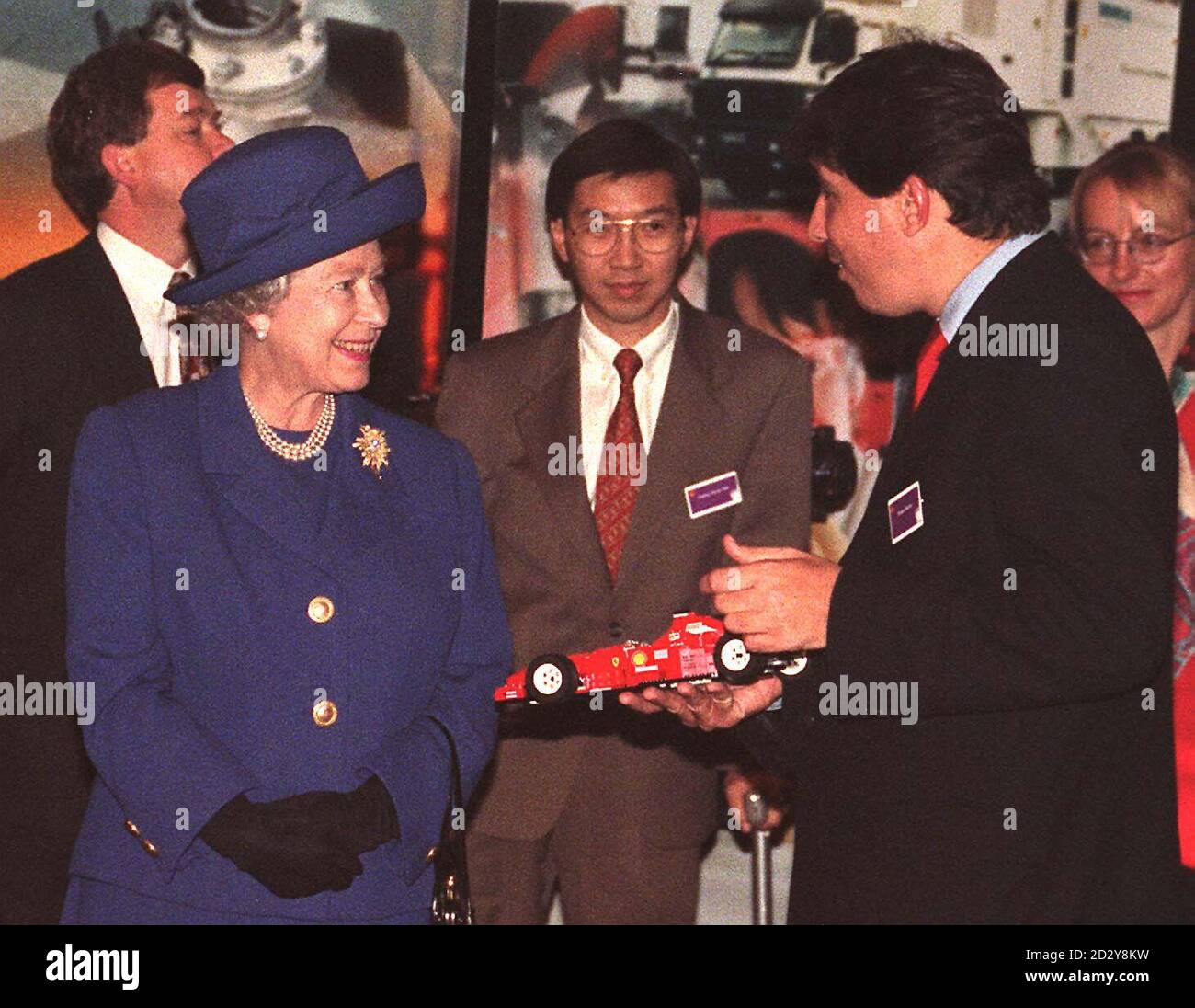 Britain's Queen Elizabeth II is shown a model Ferrari Racing car during visit to the Shell Centre in London, today (Tuesday). Headquarters of the Shell Oil and exploration company, were she unveiled a sculpture marking the centenary of the founding of the company .AFP/WPA ROTA-PAUL VICENTE Stock Photo