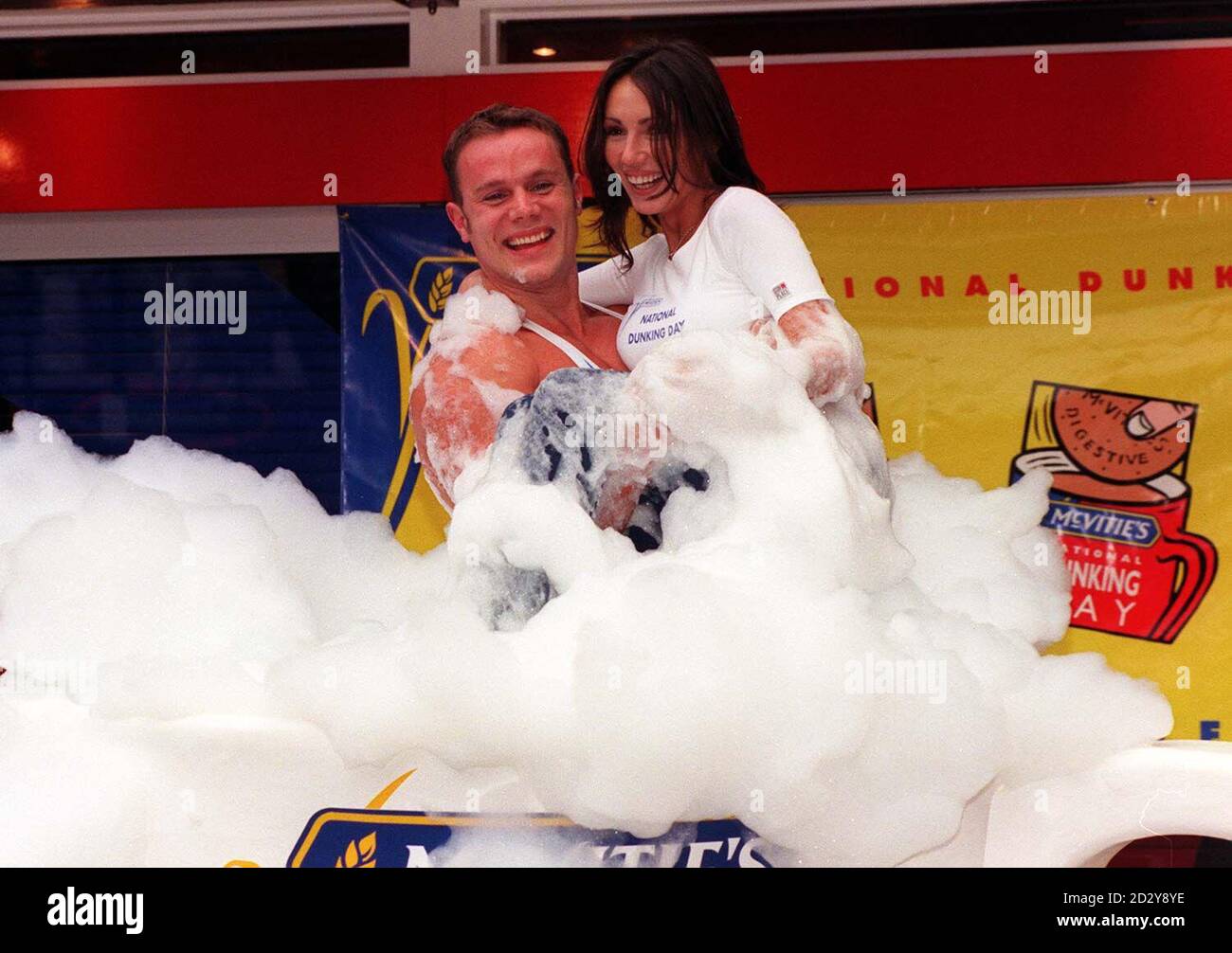 Model Kathy Lloyd and TV Gladiator 'Ace' dunk themselves in a giant tea cup of soap suds to launch McVitie's biscuits 'Annual National Dunking Day' outside the Capital Radio Cafe in central London this morning (Sunday).  Photo by Peter Jordan/PA Stock Photo