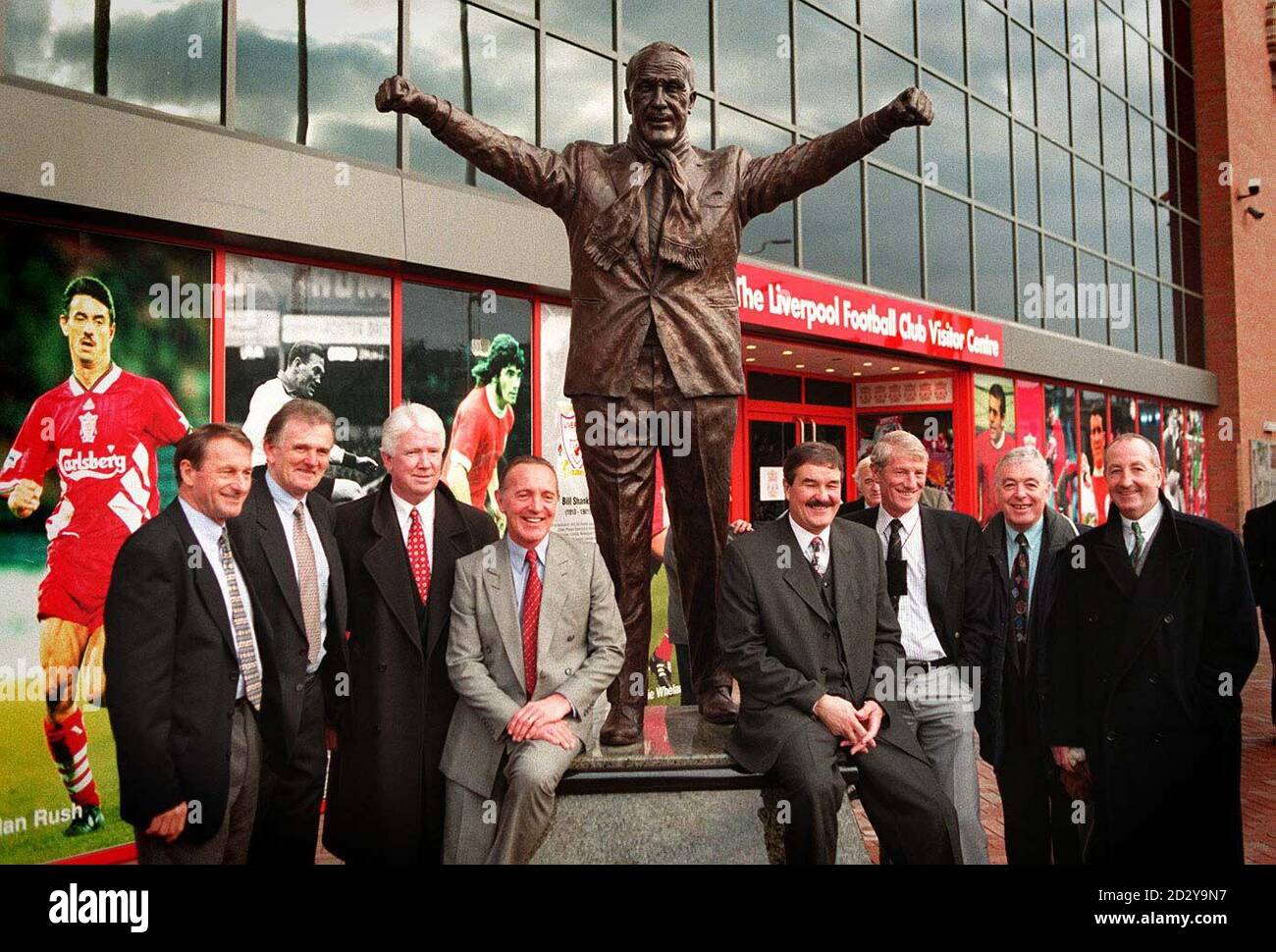 Liverpool greats from the past gather in front of the statue of the club's legendary manager, Bill Shankly, which was unveiled outside Anfield today (Thursday).  The bronze statue, created by local artist Tom Murphy and commissioned by the club's sponsors Carlsberg, is now a permenant fixture welcoming every Kop fan to the ground. Left to right: Roger Hunt, Tommy Lawrence, Chris Lawler, Peter Thompson, Ron Yeats, Willie Stevenson, Ian Callaghan and Gerry Byrne. Stock Photo
