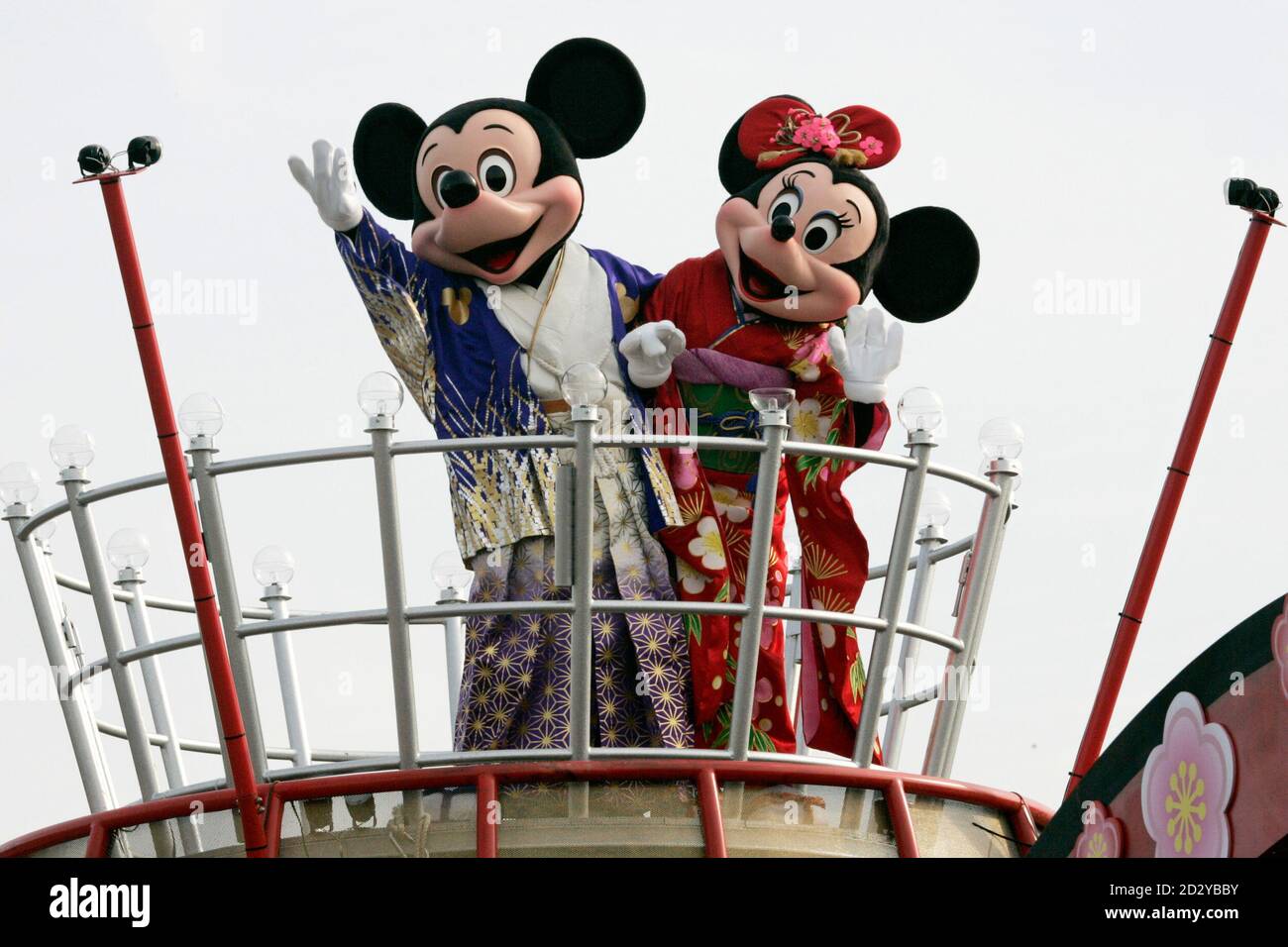 Disney cartoon characters Mickey (L) and Minnie Mouse, dressed in kimonos,  wave atop a float during New Year celebrations at Tokyo Disneyland in  Urayasu, east of Tokyo, January 1, 2007. REUTERS/Issei Kato (