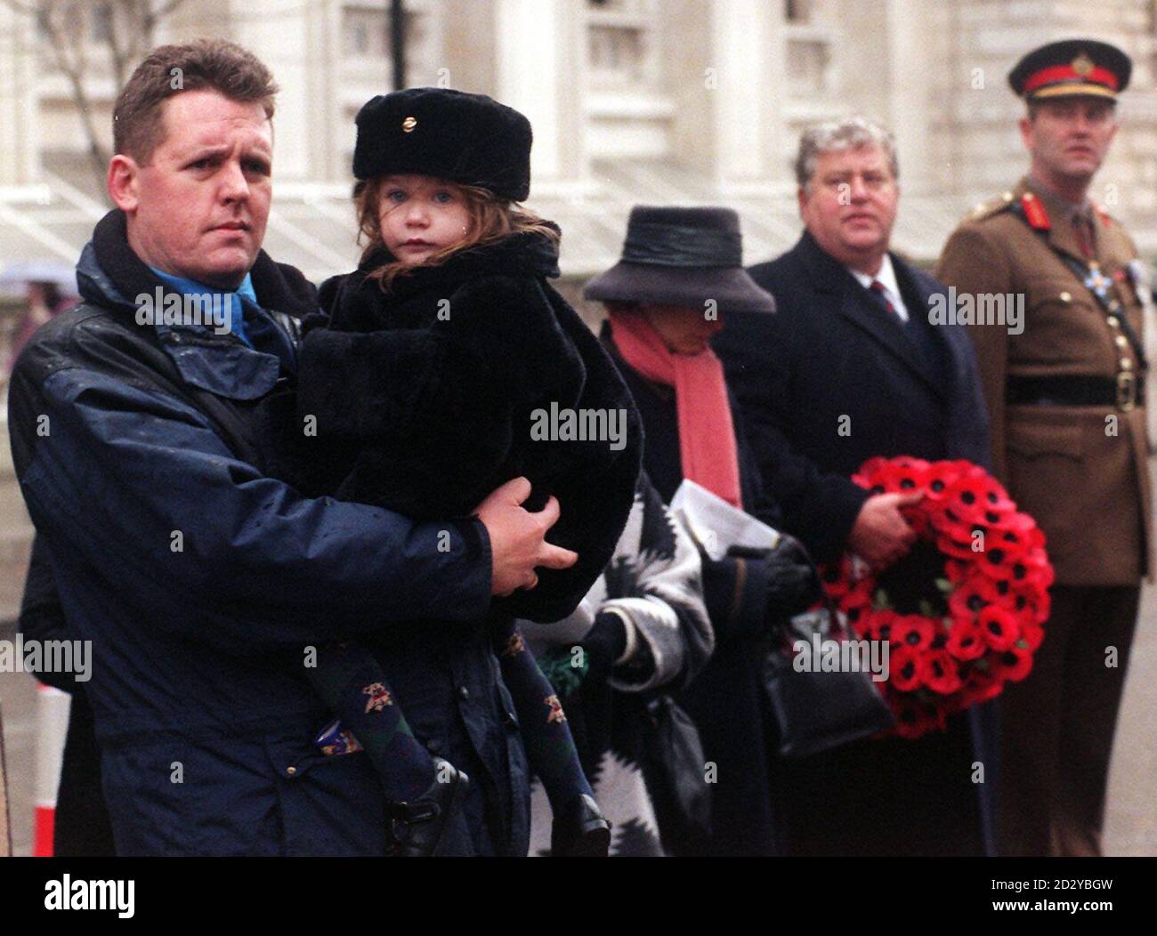 Gulf war veterans gathered at the Cenotaph in London today (Sunday), for an annual remembrance parade and said they still want answers from the Government about Gulf War Syndrome. Stephen Moss (left) from Felixstowe, Suffolk, who travelled to London for the parade, believes the Government is not doing enough to help sick veterans and their families. His two-year-old daughter Samantha was born with only one ear which the former guardsman with the Scots Guards believes is a result of injections given to him in the Gulf. See PA Story DEFENCE Veterans. Photo by Sean Dempsey/PA. Stock Photo