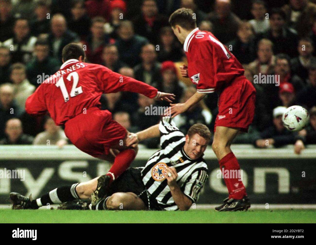 Newcastle's Steve Watson is tackled by Liverpool's Michael Owen (right) and Steve Harkness at Anfield tonight (Tuesday). Photo by Owen Humphreys/PA. Stock Photo