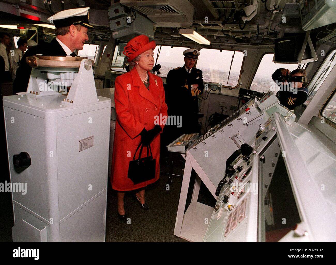 Her Majesty the Queen stands on tip toe to see over the bridge of the Royal Navy's newest and largest ship, HMS Ocean, during a tour prior to the formal naming ceremony at the VSEL Shipyard at Barrow in Furness today (Friday ). ROTA Photo John Giles/PA. Stock Photo