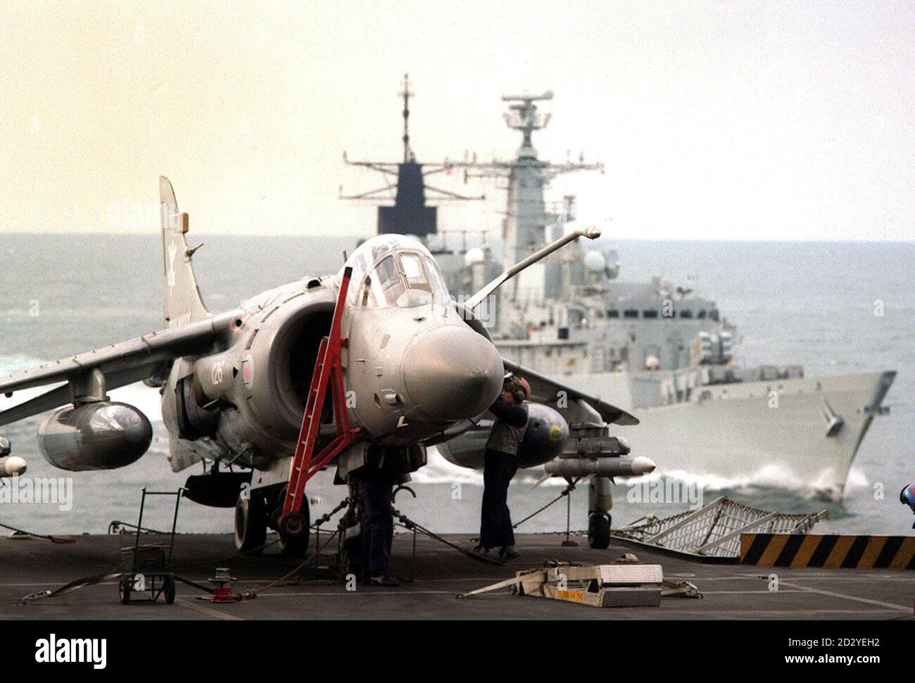 Hms coventry rear sails past aircraft carrier hms invincible hires