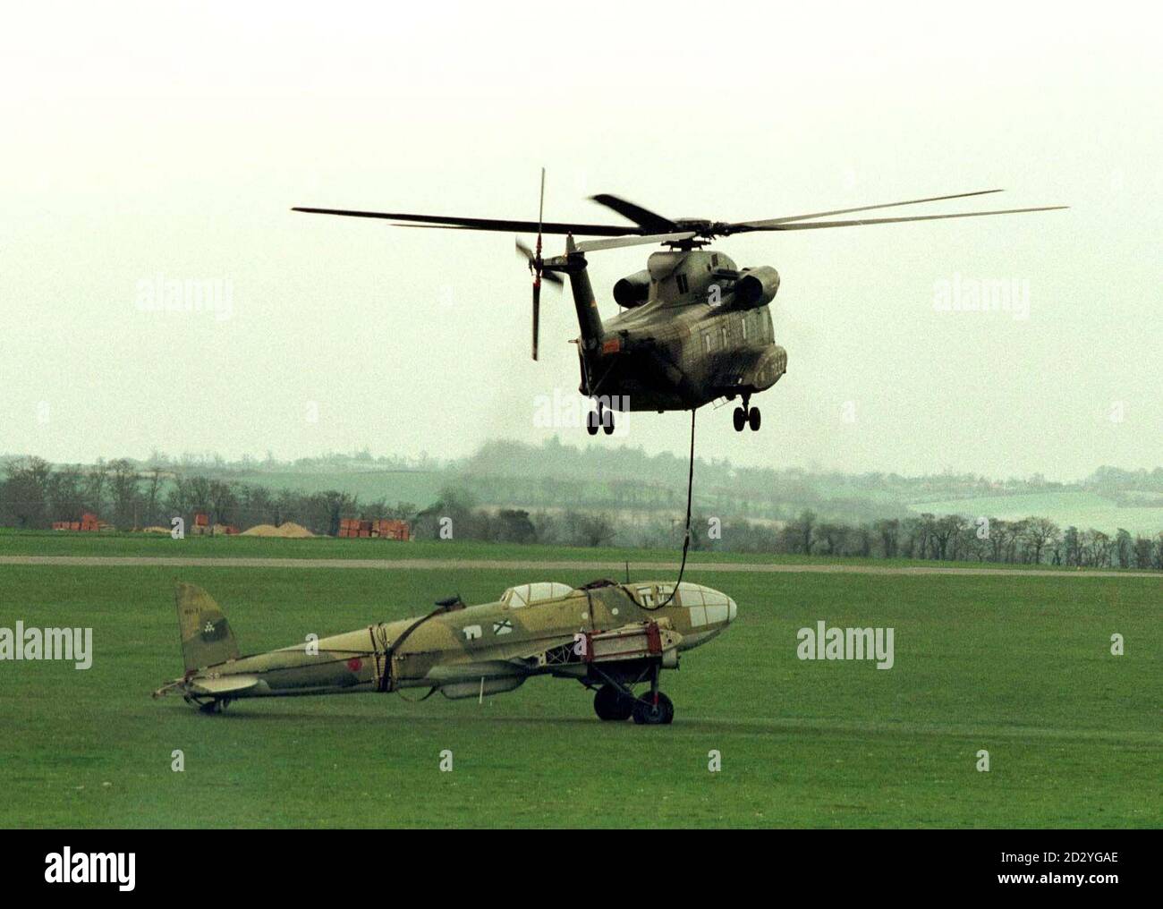 A CH 51 'Jolly Green Giant' helicopter of the German Army with the cargo of a Heinkel Bomber arrives at the Imperial War Museum at Duxford in Cambridgeshire today (Friday) after a three day journey from Seville, Spain. The Heinkel Save serviced with the Spanish Airforce until the 1960's and will be restored by the Old Flying Machine Company, based at Duxford, at an approximate cost of  1 million.  Photo by Findlay Kember/PA Stock Photo