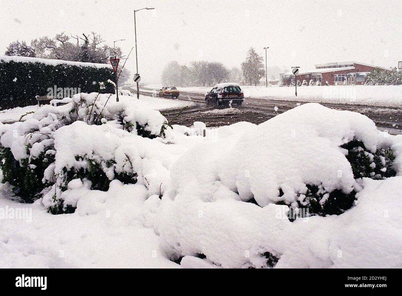 Cars battle through the snow covered roads of Oswestry in Shropshire