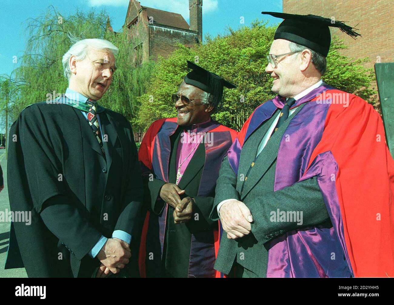 Archbishop Dr Desmond Tutu (centre) speaks to TV/radio presenter John Humphrys (left) and pathologist Bernard Knight, at the University of Wales, in Cardiff, today (Saturday), where they are among 15 people whose achievements in public, academic and cultural life are being recognised by the University. See PA story AWARDS Tutu. /PA Stock Photo