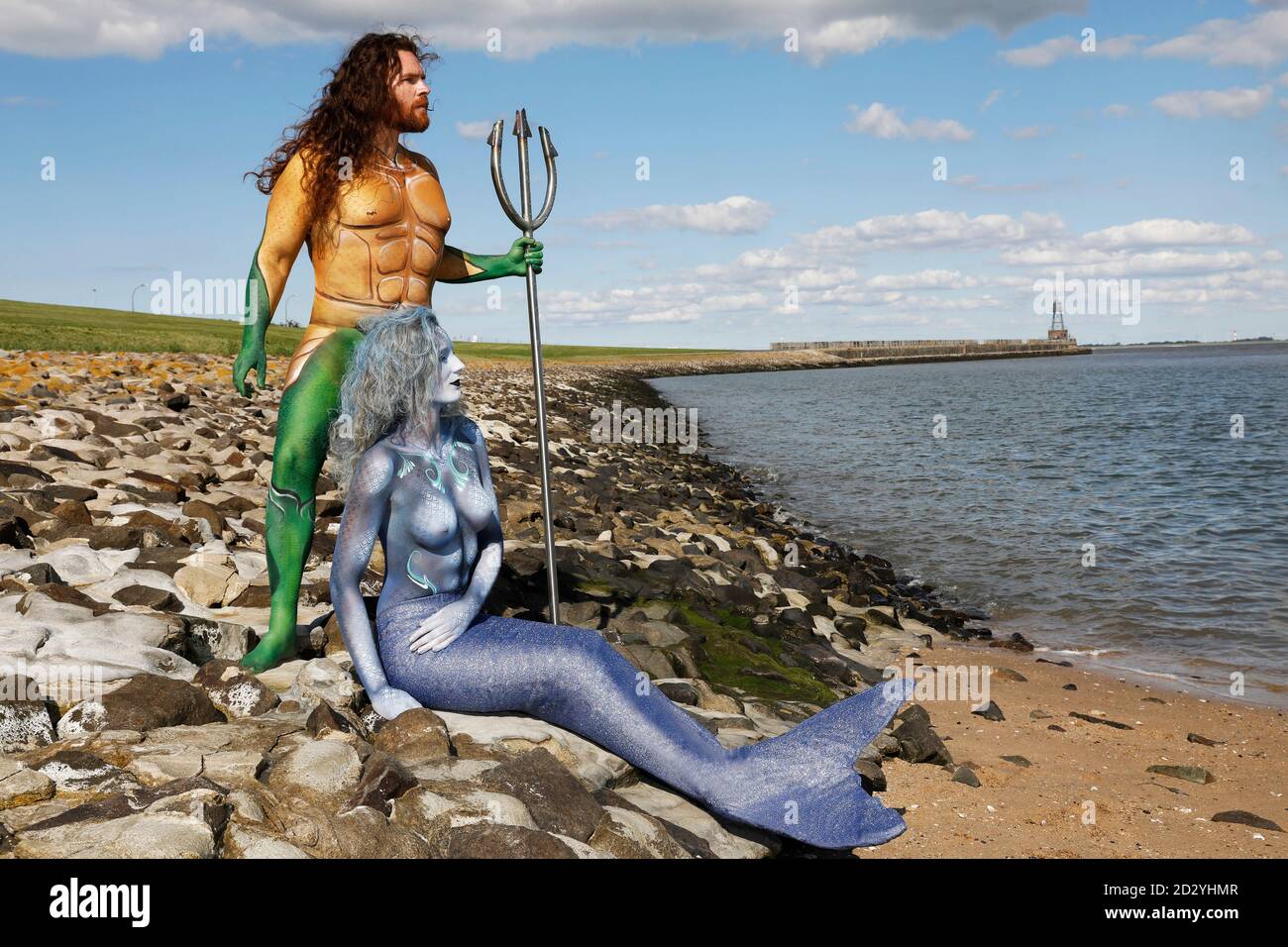 From the FARBKORPER calendar 2021 - Geek Art-Bodypainting and Transformaking: Aquaman and Nixe Photoshooting with Grave Artist and Janina S. at the Jadebusen in Wilhelmshaven. A project by the photographer Tschiponnique Skupin and the body painter and transformaker Enrico Lein | usage worldwide Stock Photo