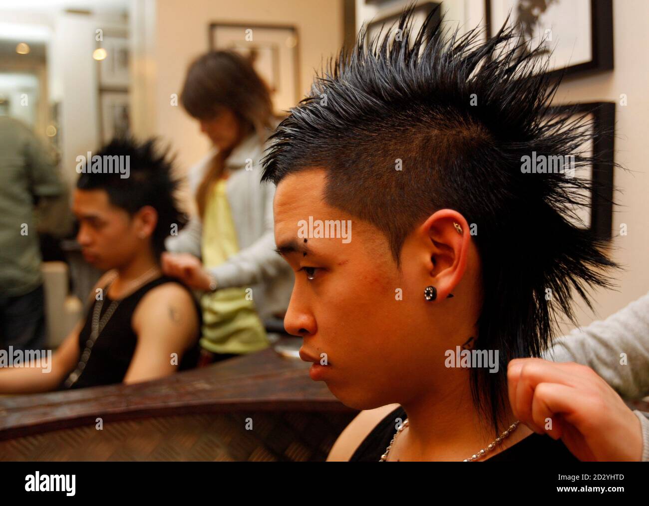 A man is seen with a 'Tecktonik' hairstyle in a hairdressing salon in Paris  March 7, 2008. Now a registered trademark -- with 33,800 related videos on  offer at  -- Tecktonik