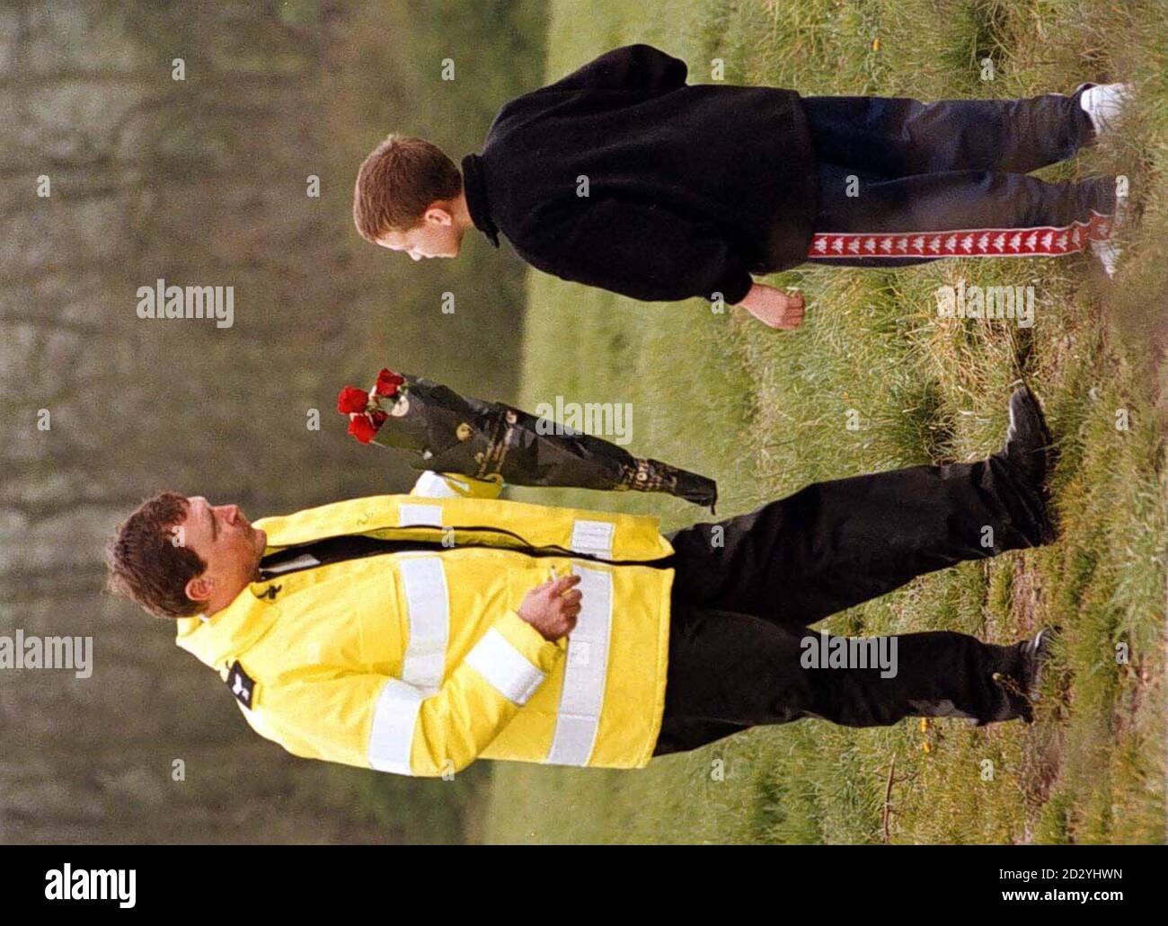 Nile Ryan, youngest son of Lottery millionaire Lee Ryan, hands over a bunch of flowers to a policeman at the site of a helicopter crash in Leicestershire today (Monday) after his father landed his own helicopter in a neighbouring field.   Mr Ryan, who took up flying after scooping his  6.5 million win two years ago, said the pilot - one of four people who were killed in the crash - was a flying friend. See PA story ACCIDENT Copter. Photo by RUI VIEIRA/PA Stock Photo