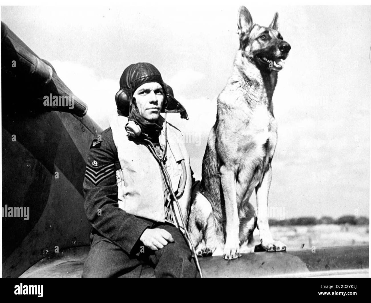 Collect photo of Wing Commander George Unwin during the Battle of Britain in 1940 with his dog 'Flash' posing by a Spitfire. Unwin is the only surviving member of 19 Squadron, the Original Spitfire Squadron. PA Photos. Stock Photo