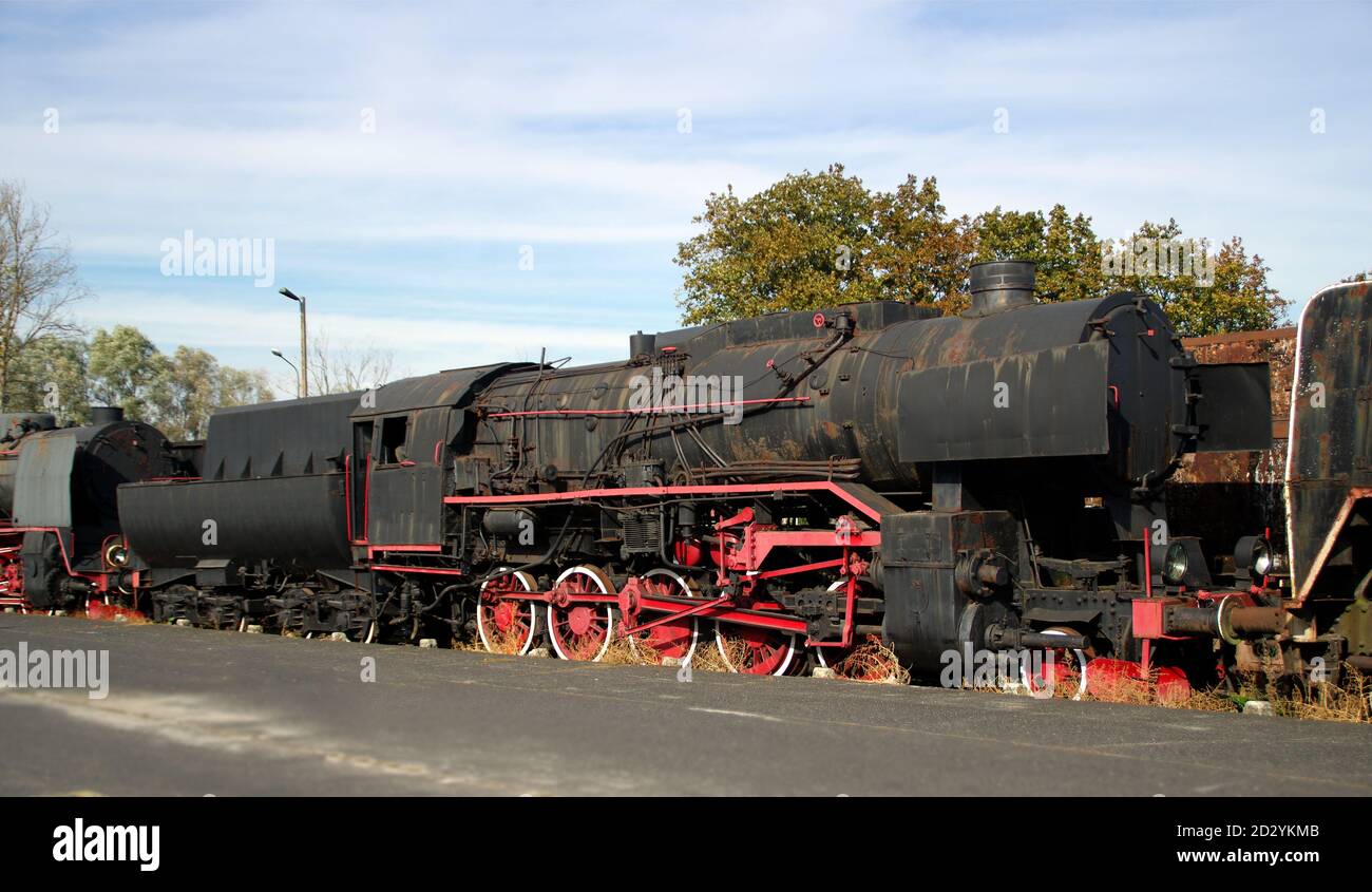 Historic coal train. Forgotten rusty steam locomotive. Nostalgia for retro machines. Stock Photo