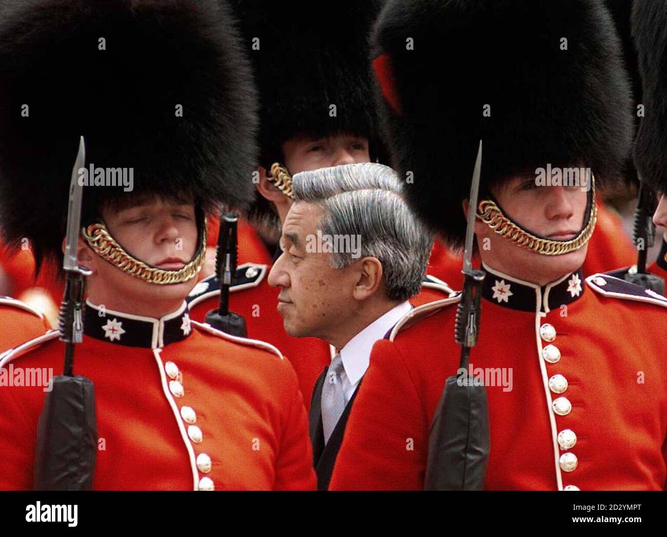 Japanese Emperor Akihito walks between ranks of soldiers as he inspects a guard of honour at the start of his state visit to Britain.  The Emperor faced a protest from hundreds of former Japanese prisoners of War who turned their back on the ceremonial procession as it passed by on its way to Buckingham Palace.   Reuters Rota. Stock Photo
