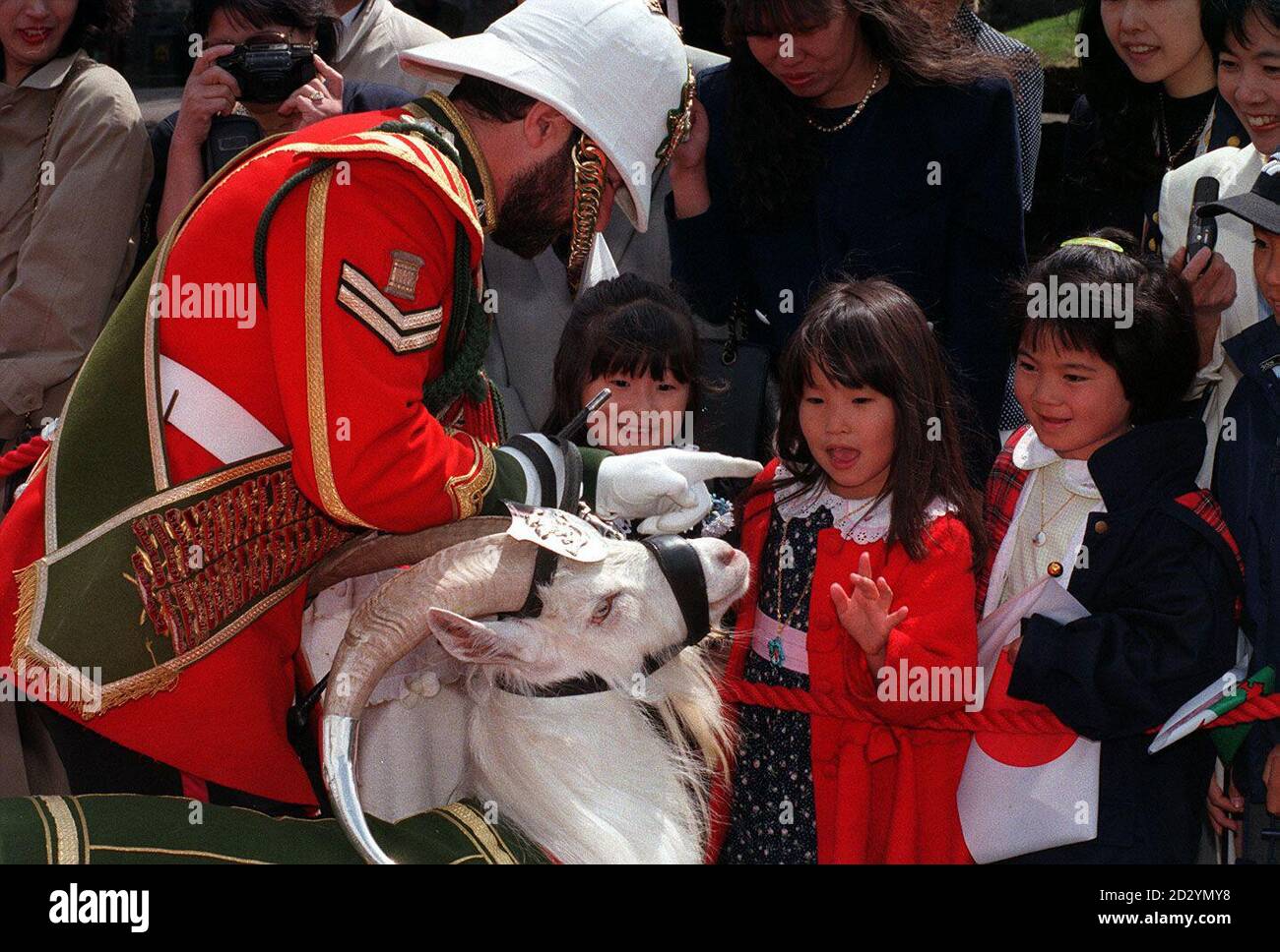 Japanese children meet Shenkin, a 22-month-old Windsor White Goat, who is Regimental mascot to the 2nd Battalion of the Royal Regiment of Wales, at Cardiff Castle today (Weds).  See PA Story ROYAL Emperor. Stock Photo