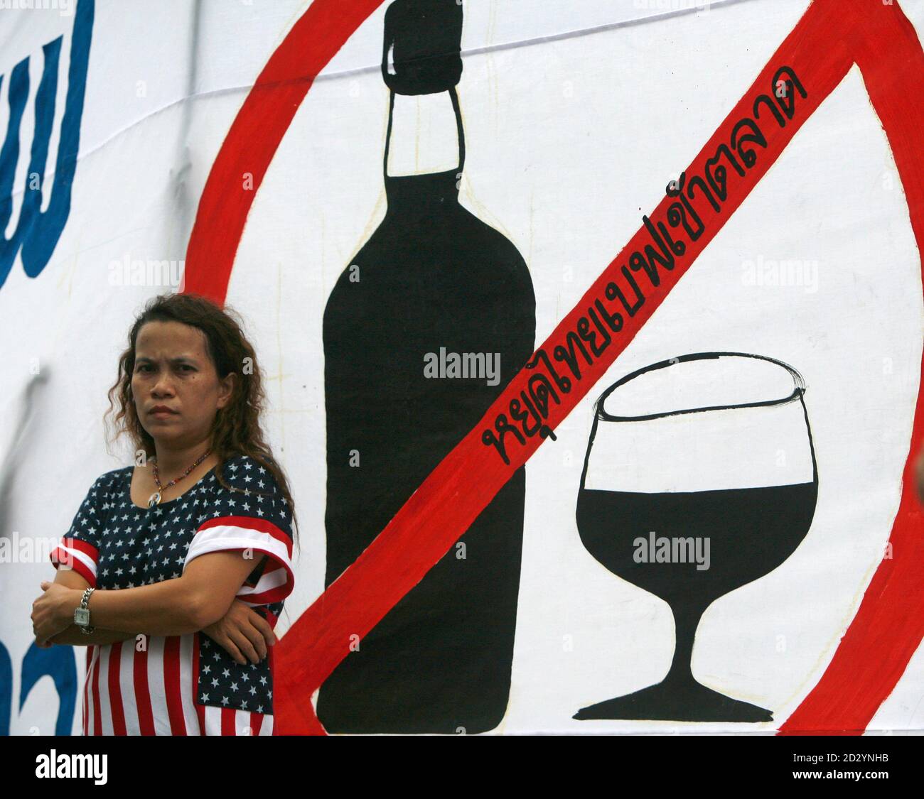 A Woman Stands In Front Of A Sign Which Reads Stop The Listing Of Thai Beverage On Stock Market As A Few Dozen Members Of Anti Alcohol Groups Gathered Outside The Stock Exchange