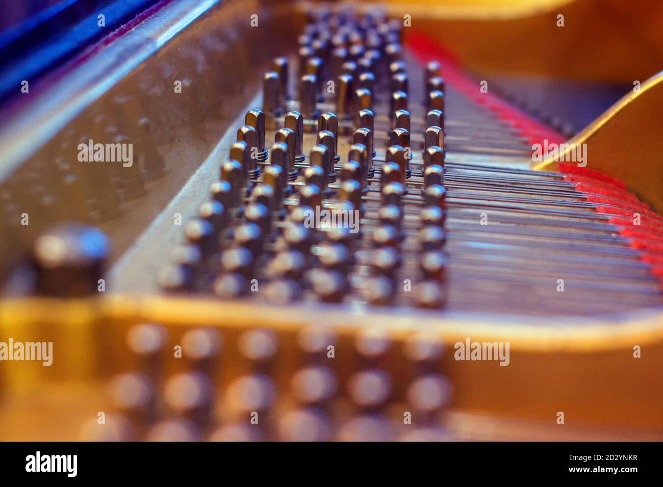The internal mechanism of the piano. The device of the concert piano from the inside. This is how the strings of a keyboard musical instrument look li Stock Photo