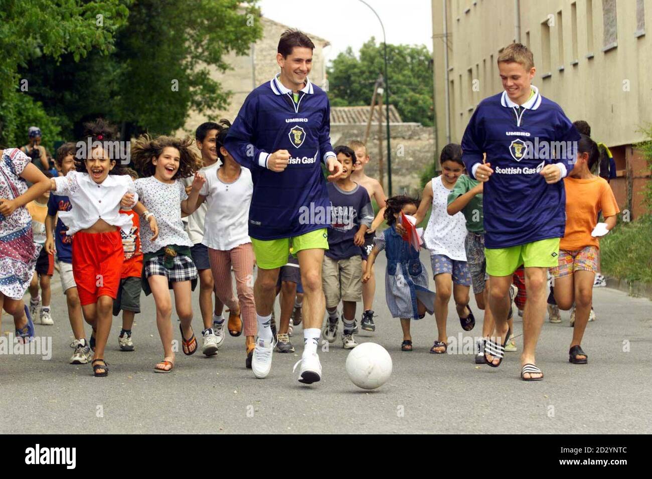 Scotland's soccer stars Jackie McNamara (left ) and Simon Donnelly showing local kids how to handle a ball in St. Remy today (Sunday) only days before their first World Cup match. EDI Photo by Chris Bacon/PA Stock Photo