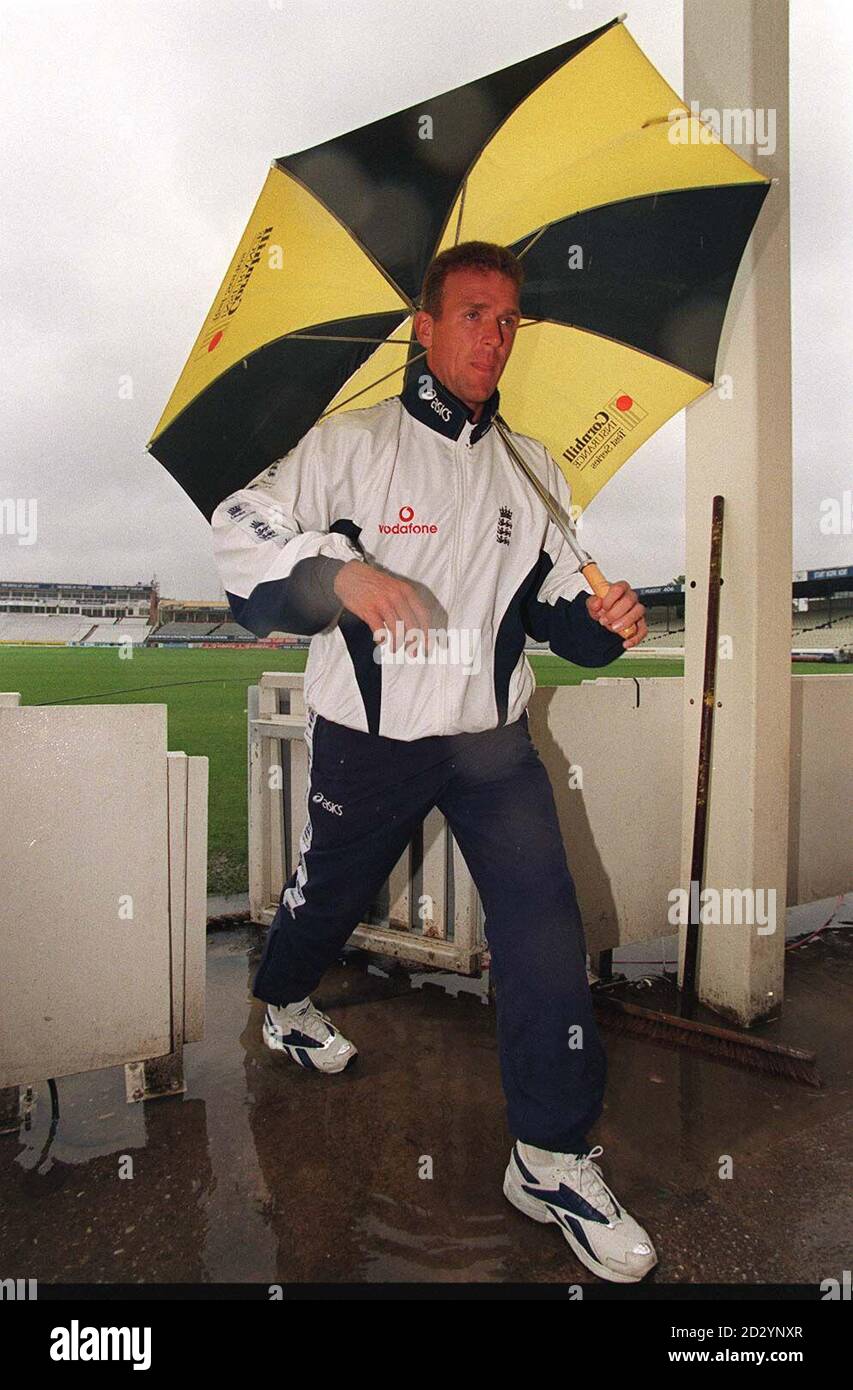 England captain Alec Stewart strides a puddle as he leaves a rain soaked Edgbaston pitch today (Monday), on the last day of the First Test between England and South Africa, abandoned due to persistent rain. Picture DAVID JONES/PA Stock Photo